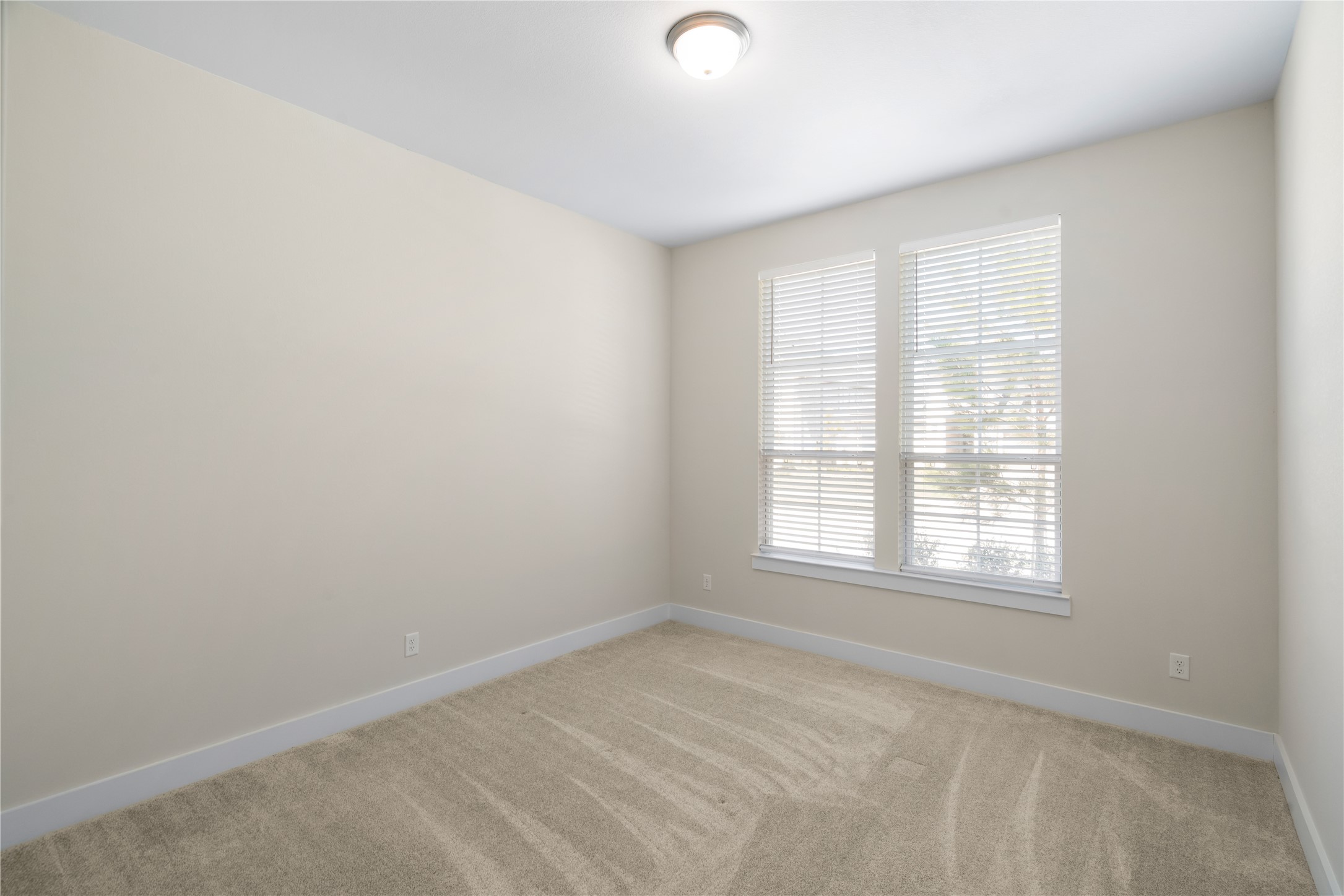 Second downstairs bedroom with an attached full bathroom.