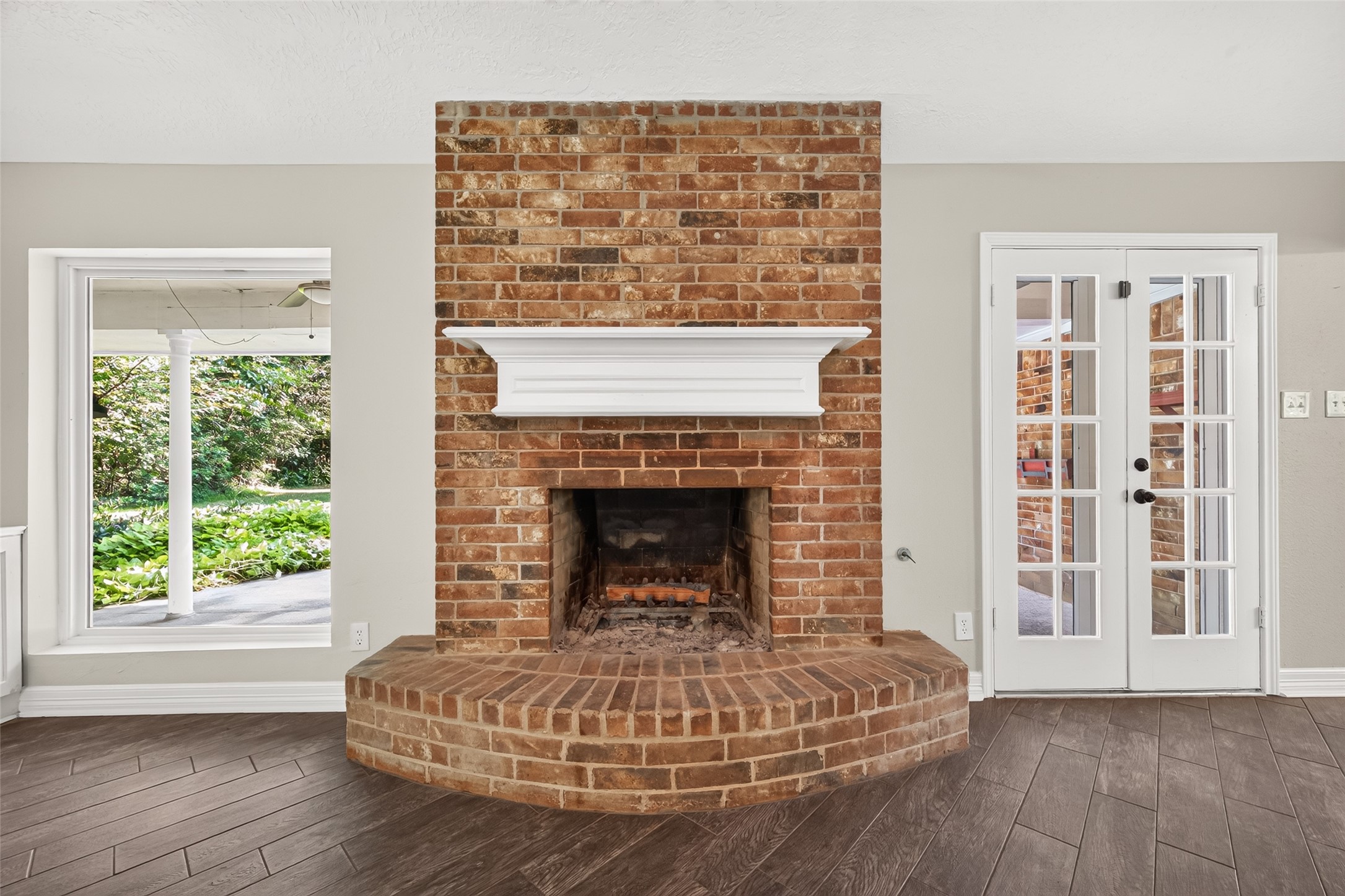 Wood-burning fireplace designed to accommodate a gas log set, offering the flexibility of gas-fire operation.