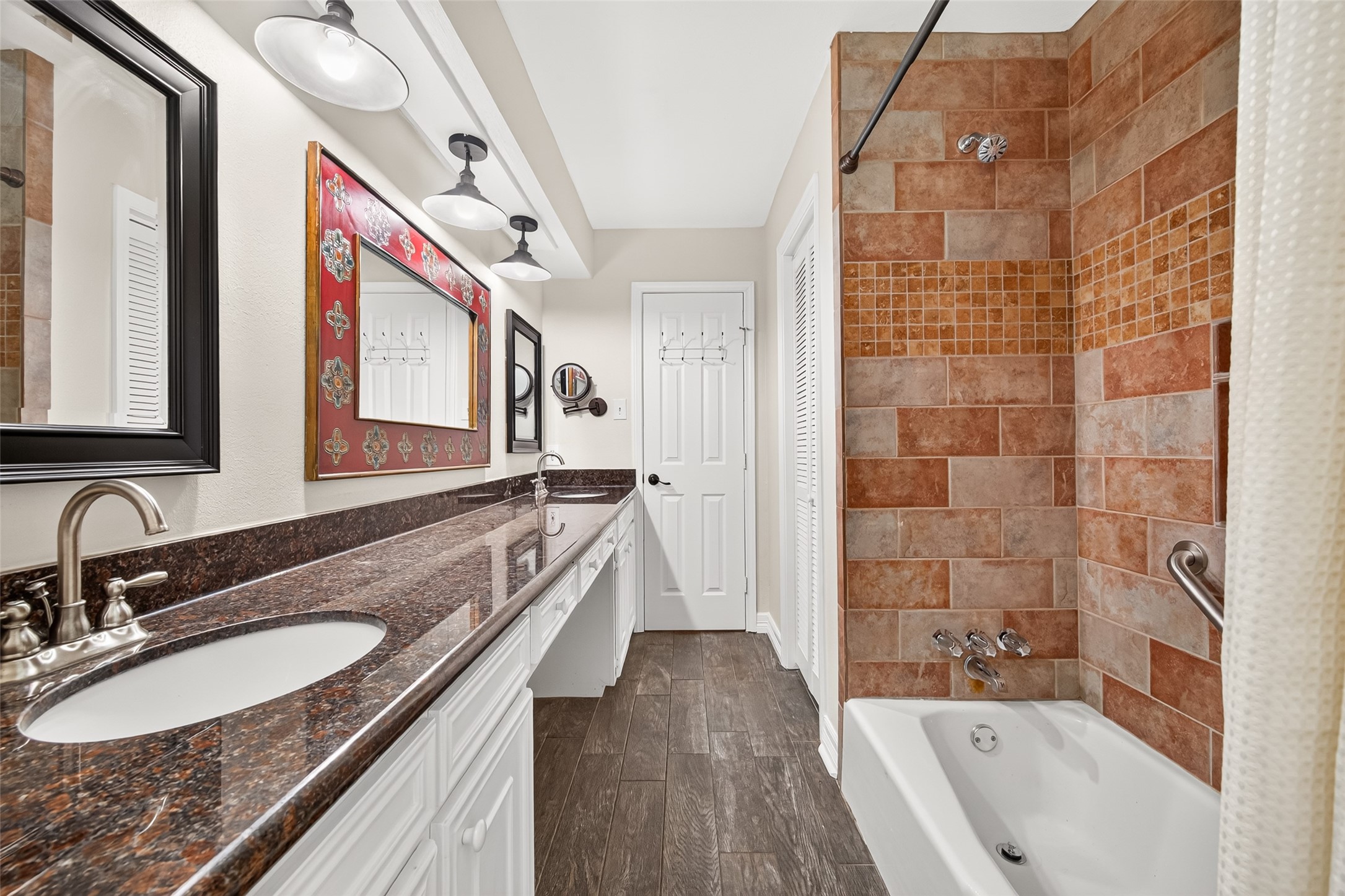 Alternate view of shared bathroom with shower and tub combo.