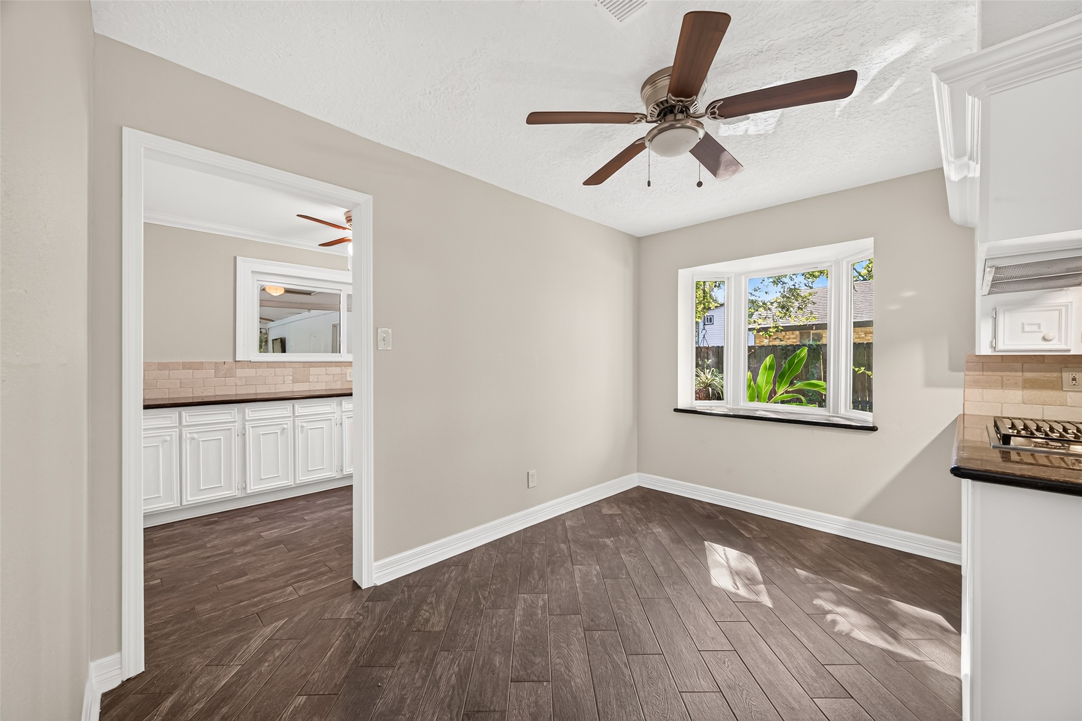 The breakfast nook is spacious and is overlooked by an beautiful way window with a granite window sill. Perfect for setting up a little herb garden or buffet.