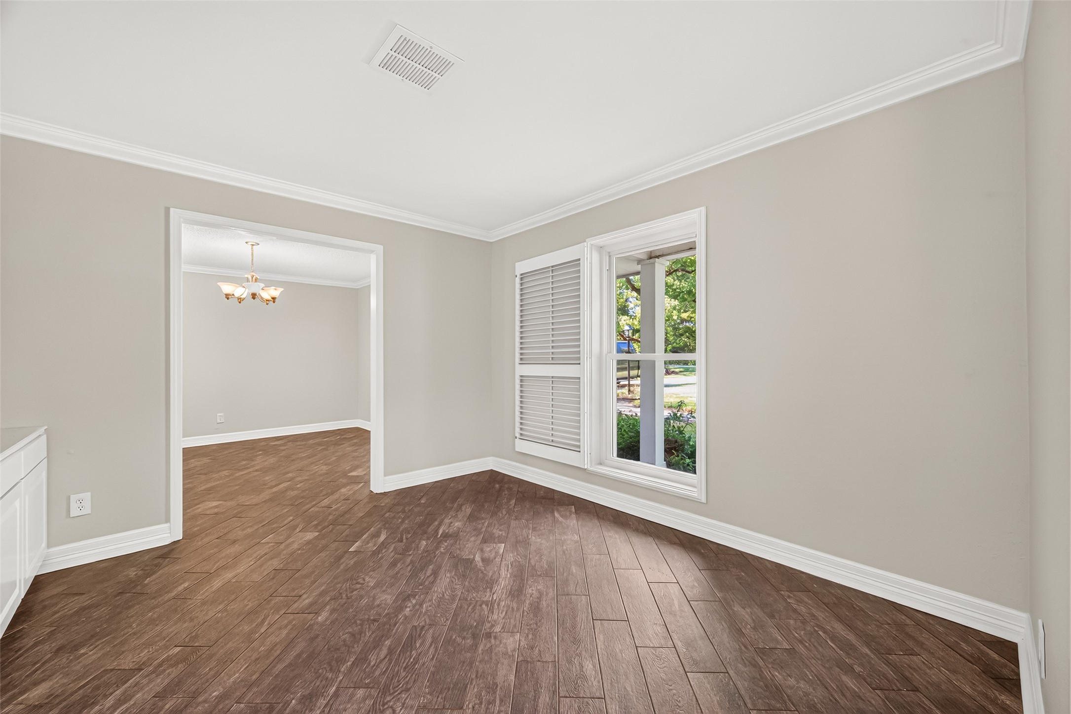 This is the study/library. The large window here is pictured with the custom shutter opened to allow the room to be lit up with natural light. Just beyond the door frame is the formal dining room.