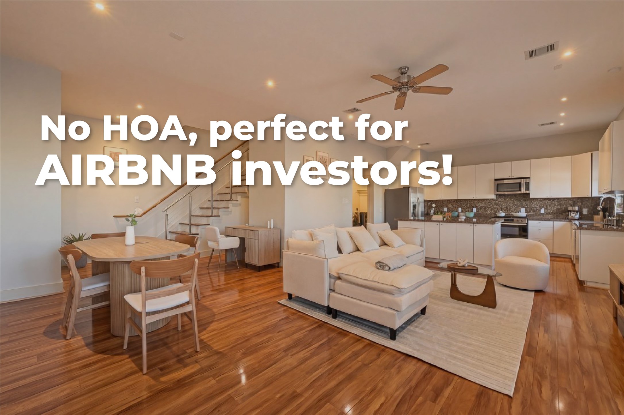 Spacious open-concept living area features sleek hardwood floors, a modern kitchen with stainless steel appliances, and a cozy seating area perfect for entertaining.