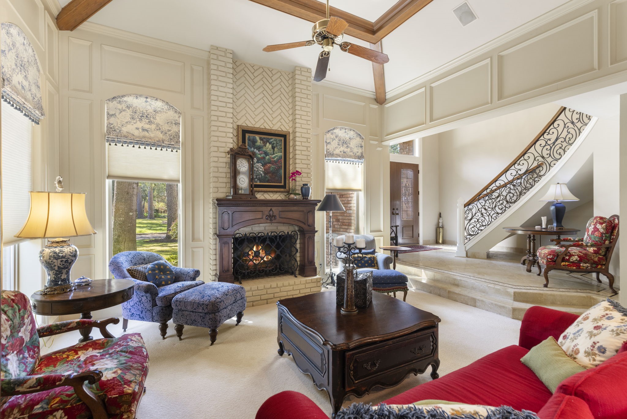 Soaring ceilings, substantial millwork, and a striking fireplace create a grand yet comfortable setting for gathering.