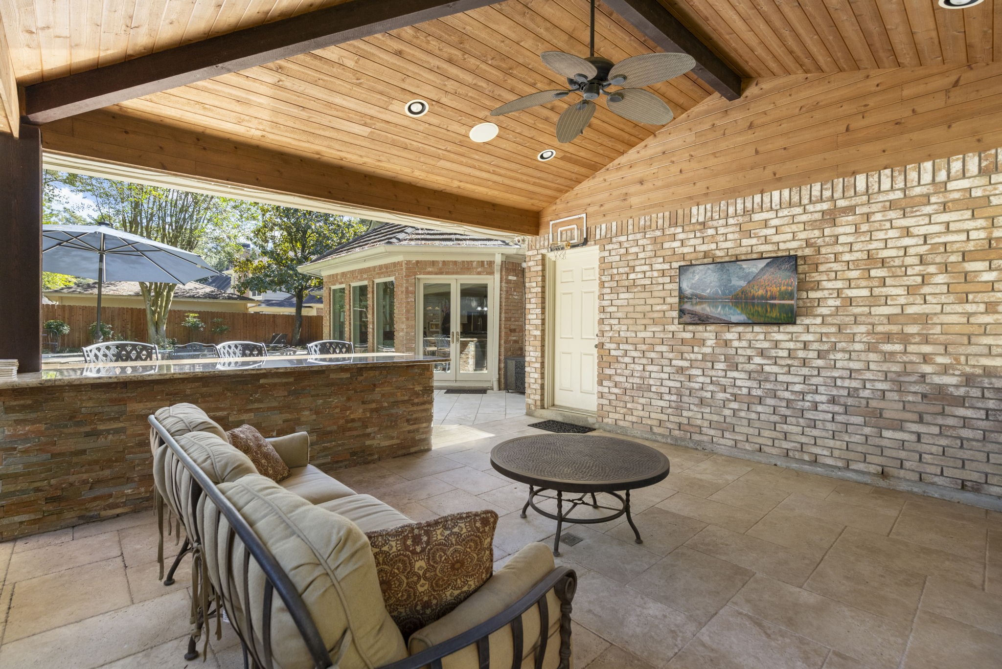 Ceiling fans and a substantial covered patio offer a comfortable place to linger between swims and outdoor meals.