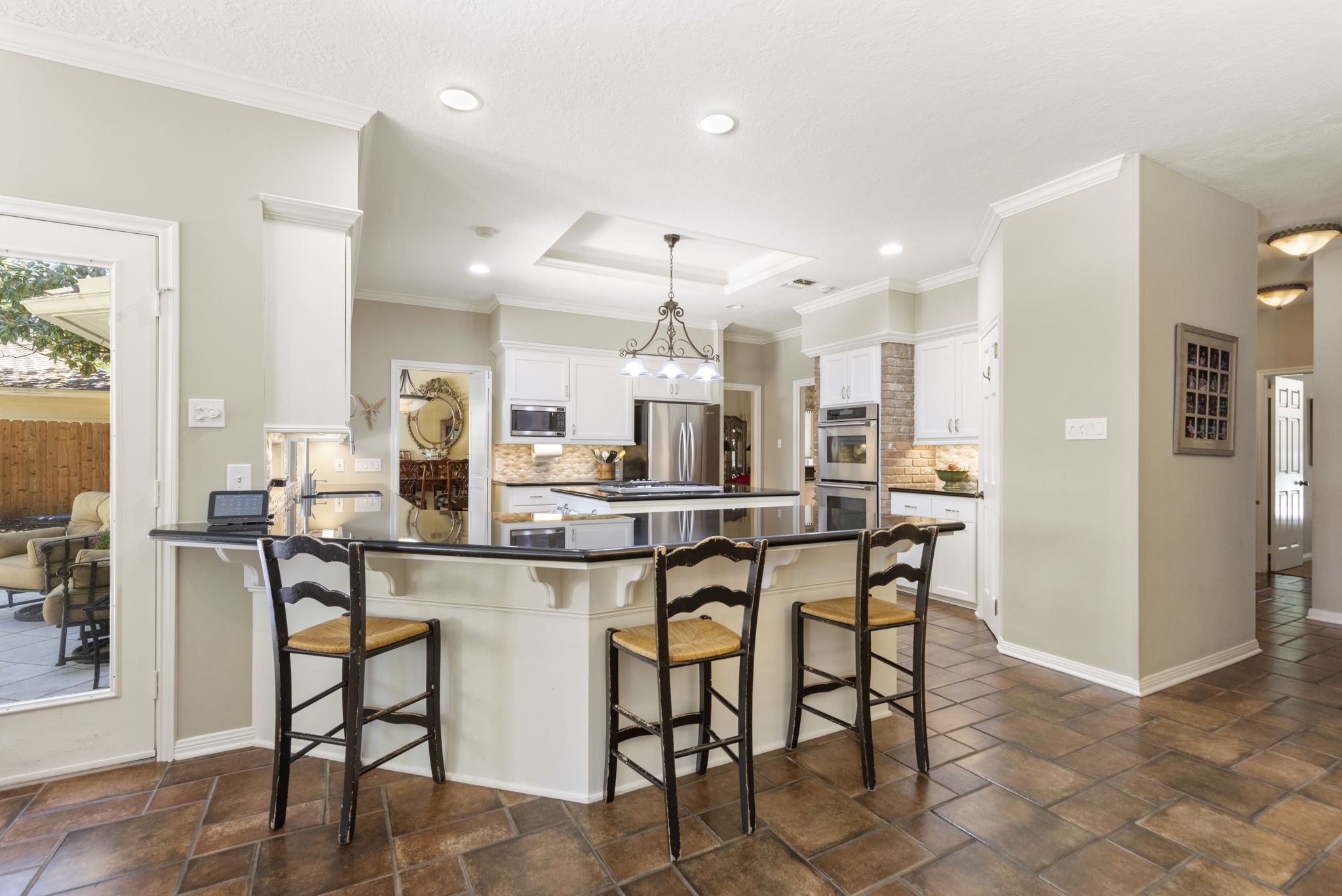 Gather around the generous breakfast bar while enjoying an open connection between the kitchen and adjoining sunroom.