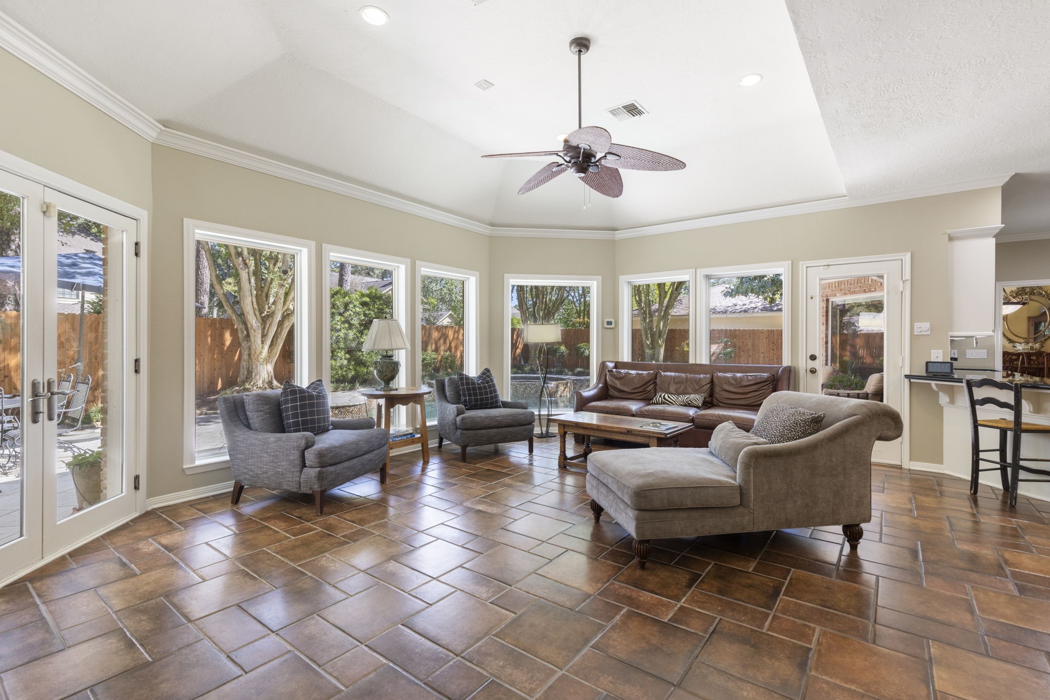 Marvin double pane windows frame the backyard in a spacious sunroom that flows naturally into the kitchen.