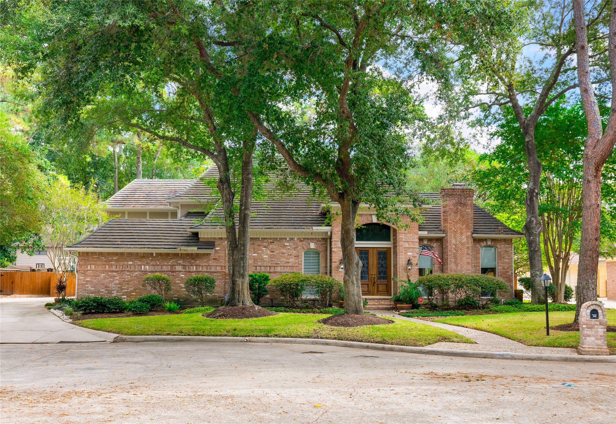 Stately brick architecture, magnificent mature trees, and a quiet cul de sac setting create an unforgettable arrival at this distinguished Huntwick home.