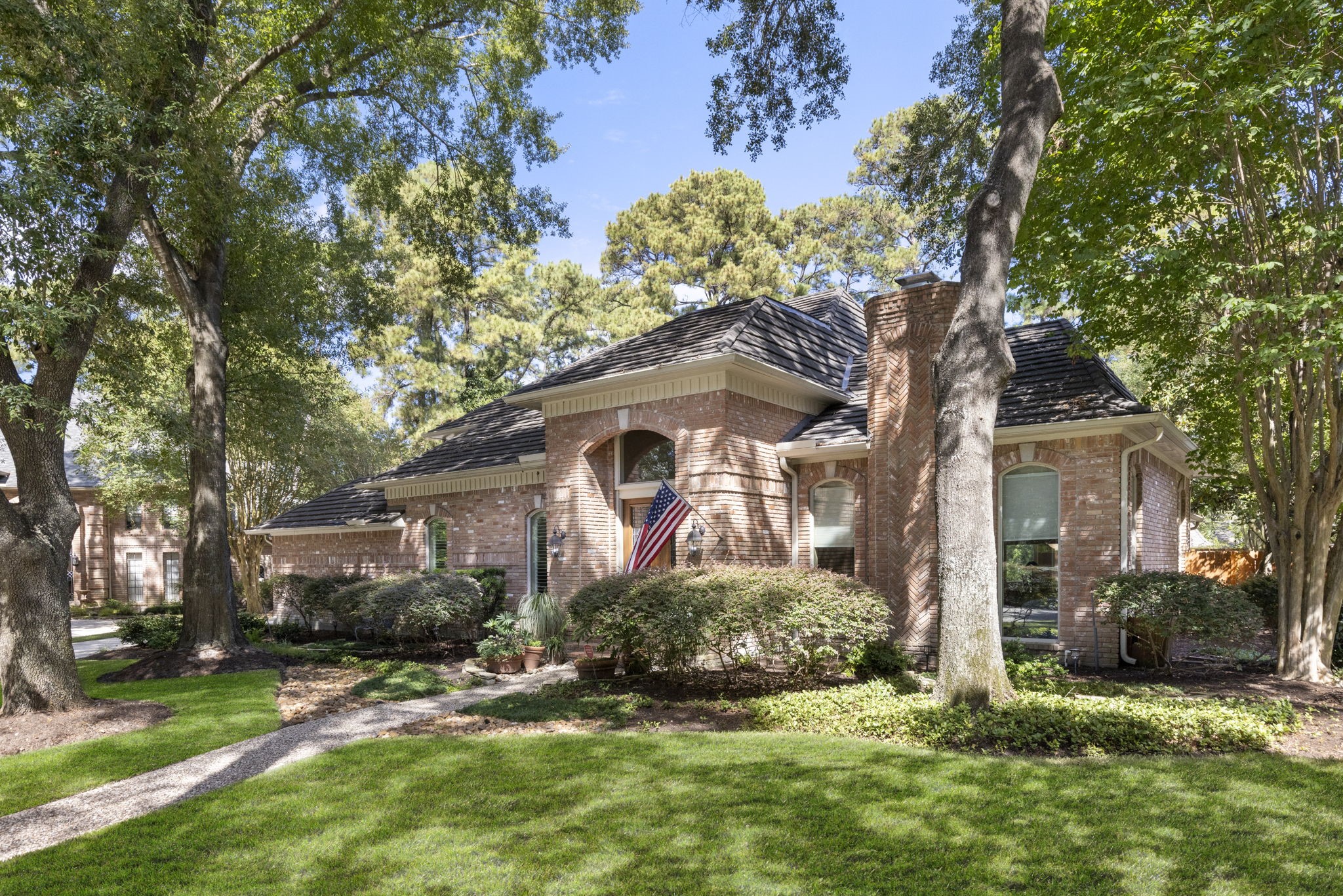 Classic brickwork and mature landscaping are complemented by a Hurricane metal shake roof installed in 2021 with a transferable warranty.