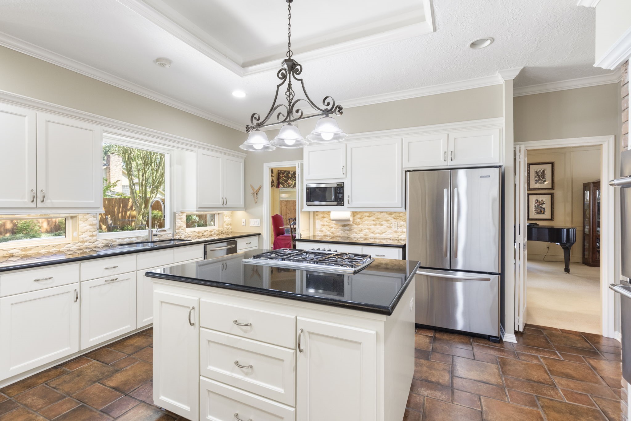 A broad window above the kitchen sink brings in natural light and keeps the backyard within view.