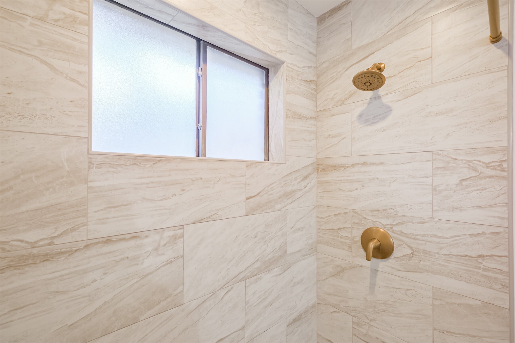 A closer look at the updated tile surround in the primary shower.