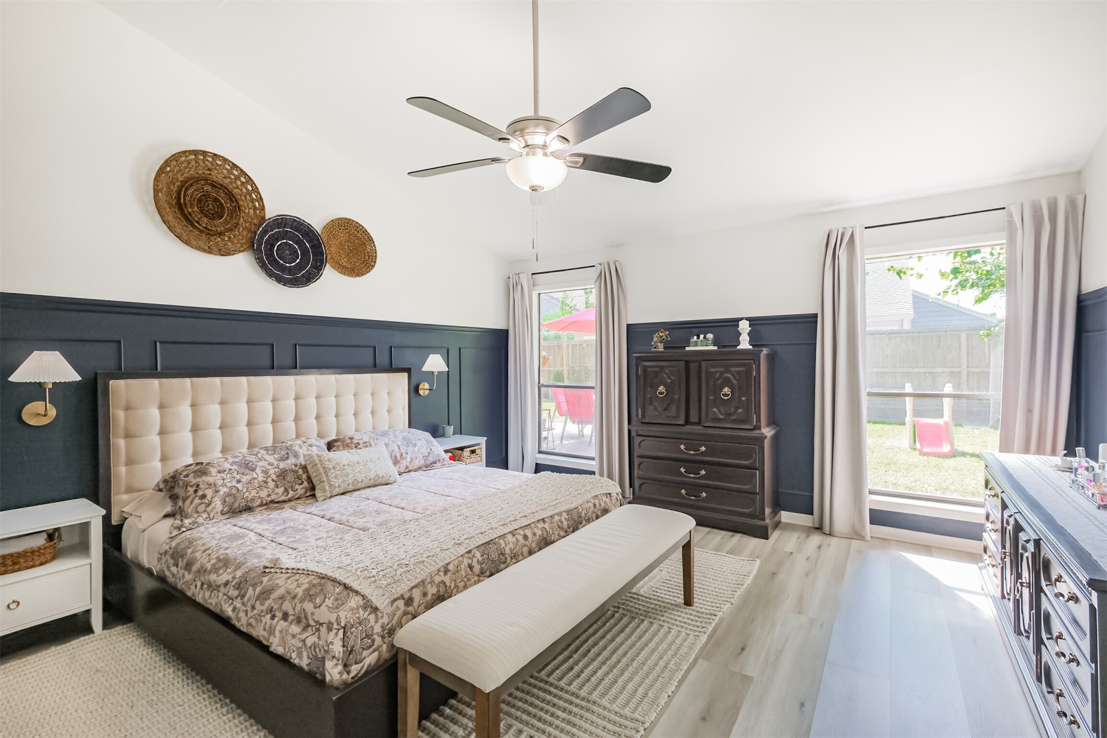 All bedrooms are located on the first floor! The primary is very spacious with high ceilings, a ceiling fan, wainscotting and views of the backyard.