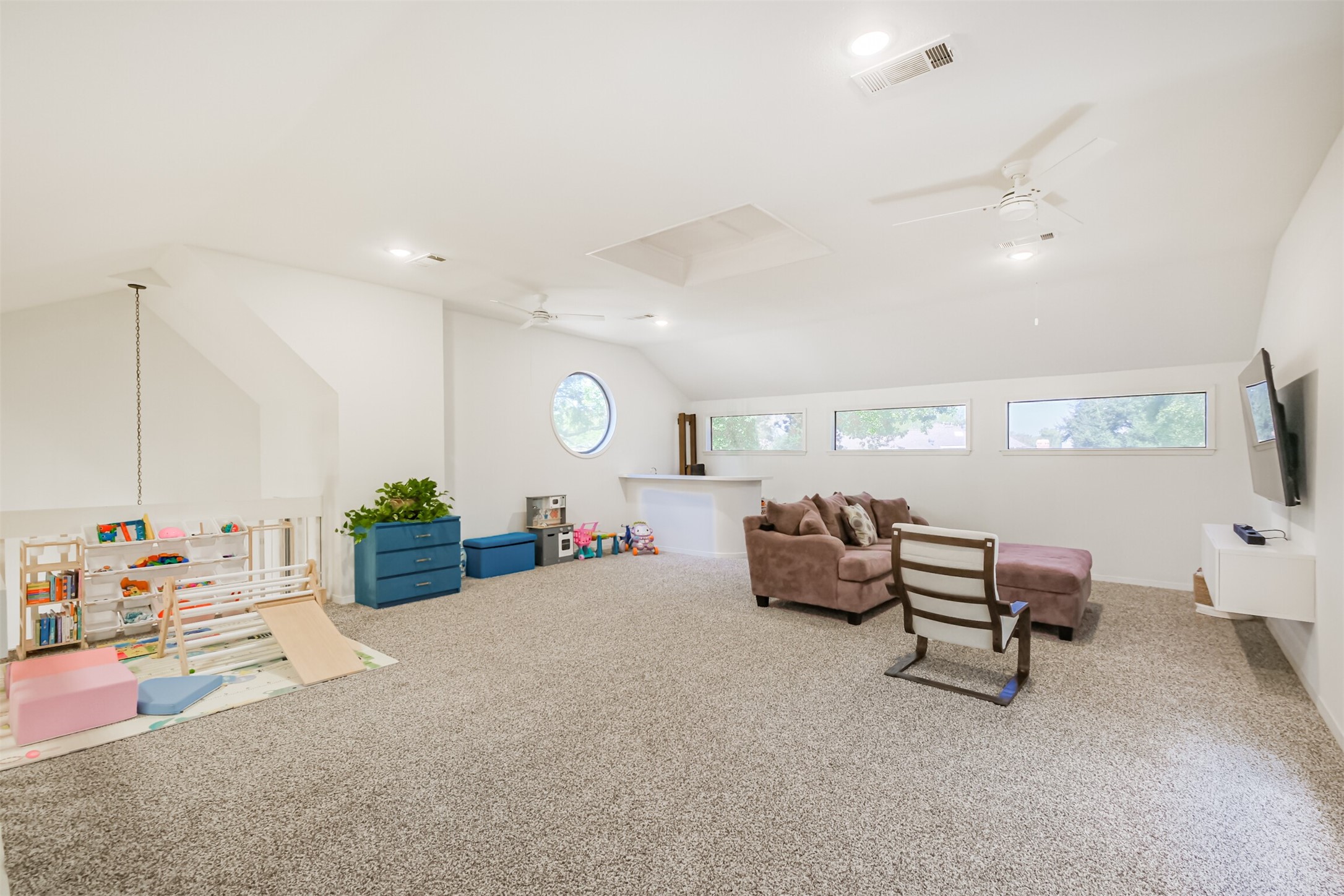 Upstairs you will find the very spacious game room with two ceiling fans and carpet floors.