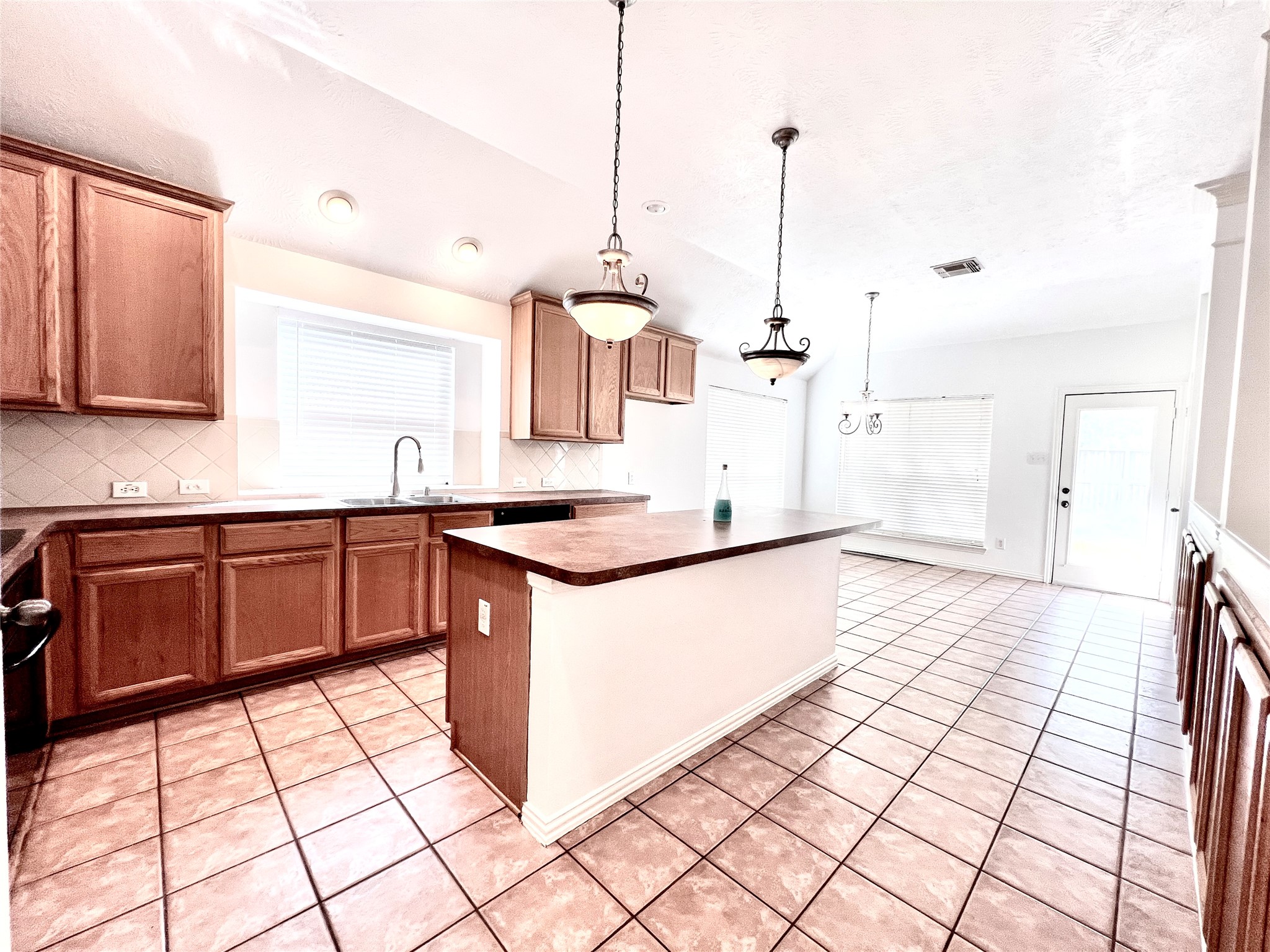 Island kitchen with ample cabintes and counter tops