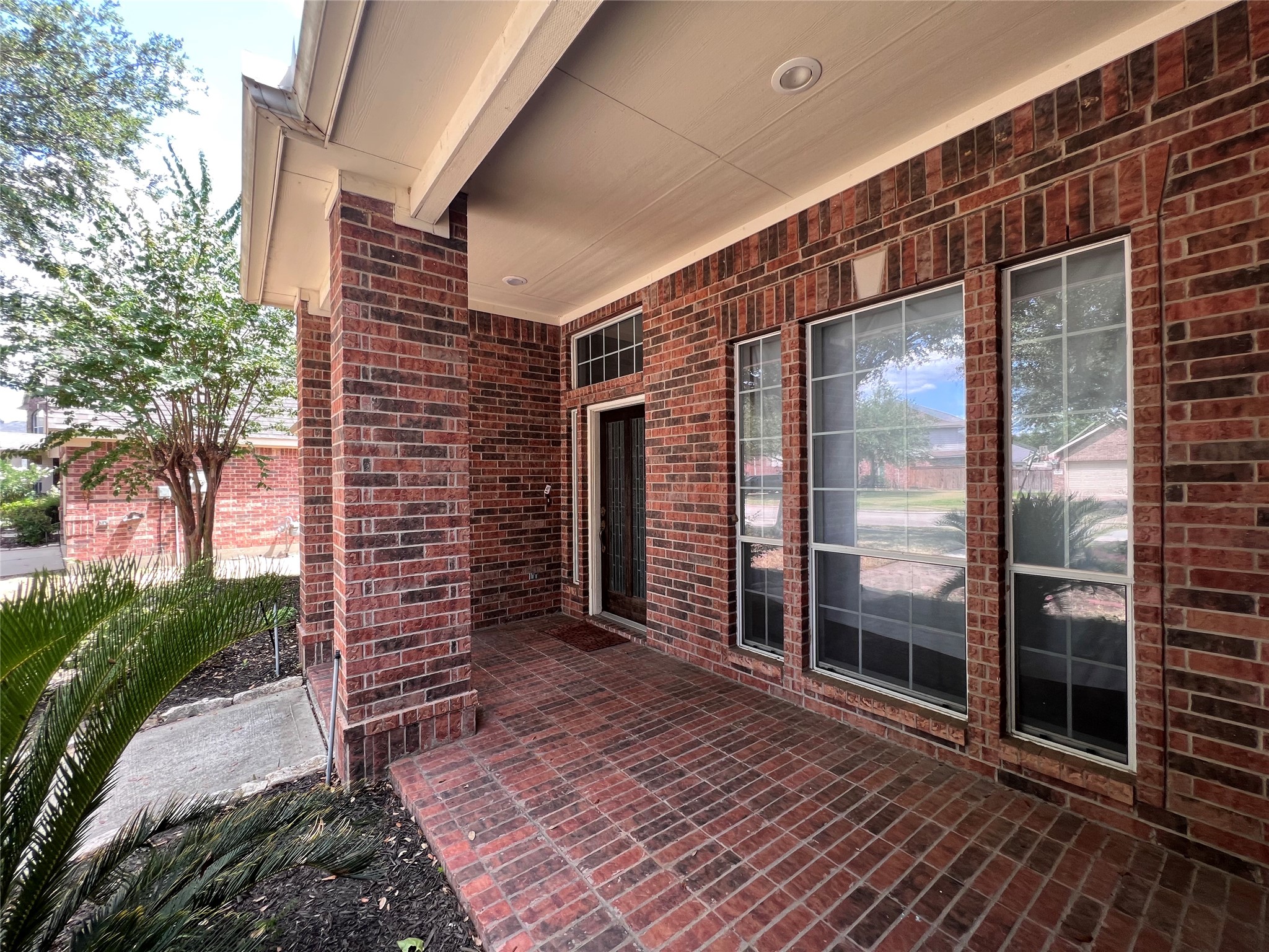 beautiful front porch with brick layer on the ground