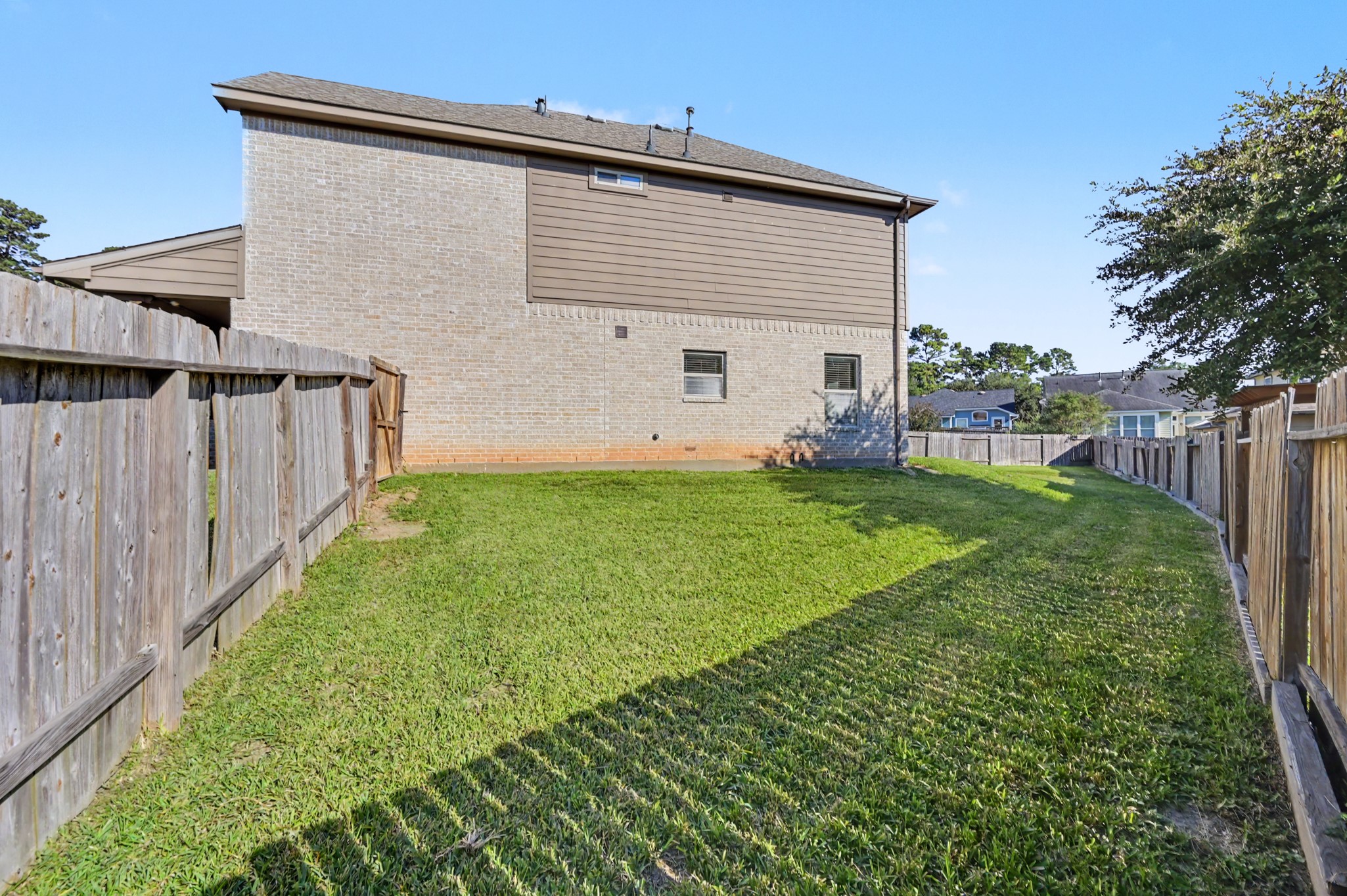 The large back yard extends to the side of the house.