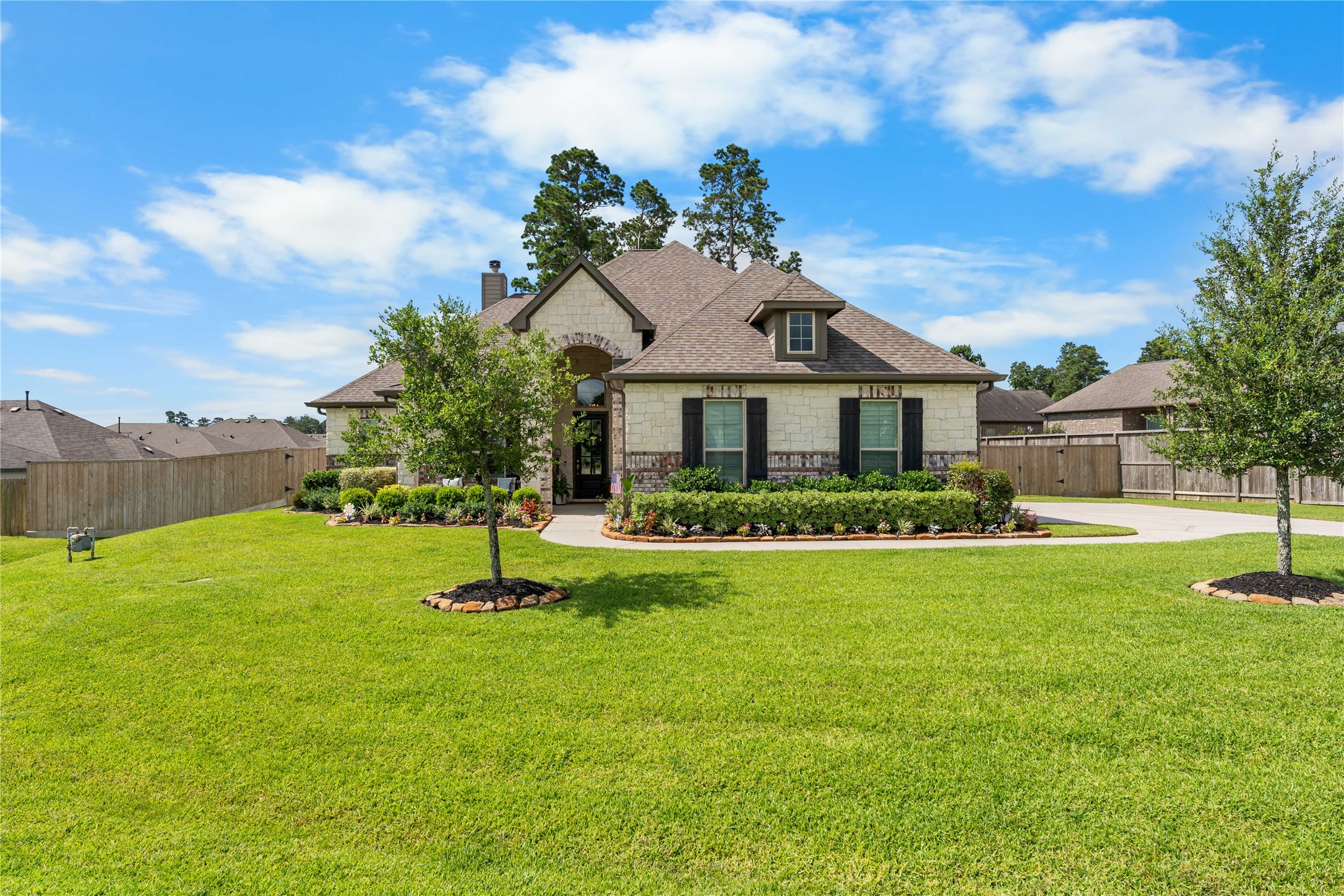 Expansive front yard with mature landscaping and elevated curb appeal.