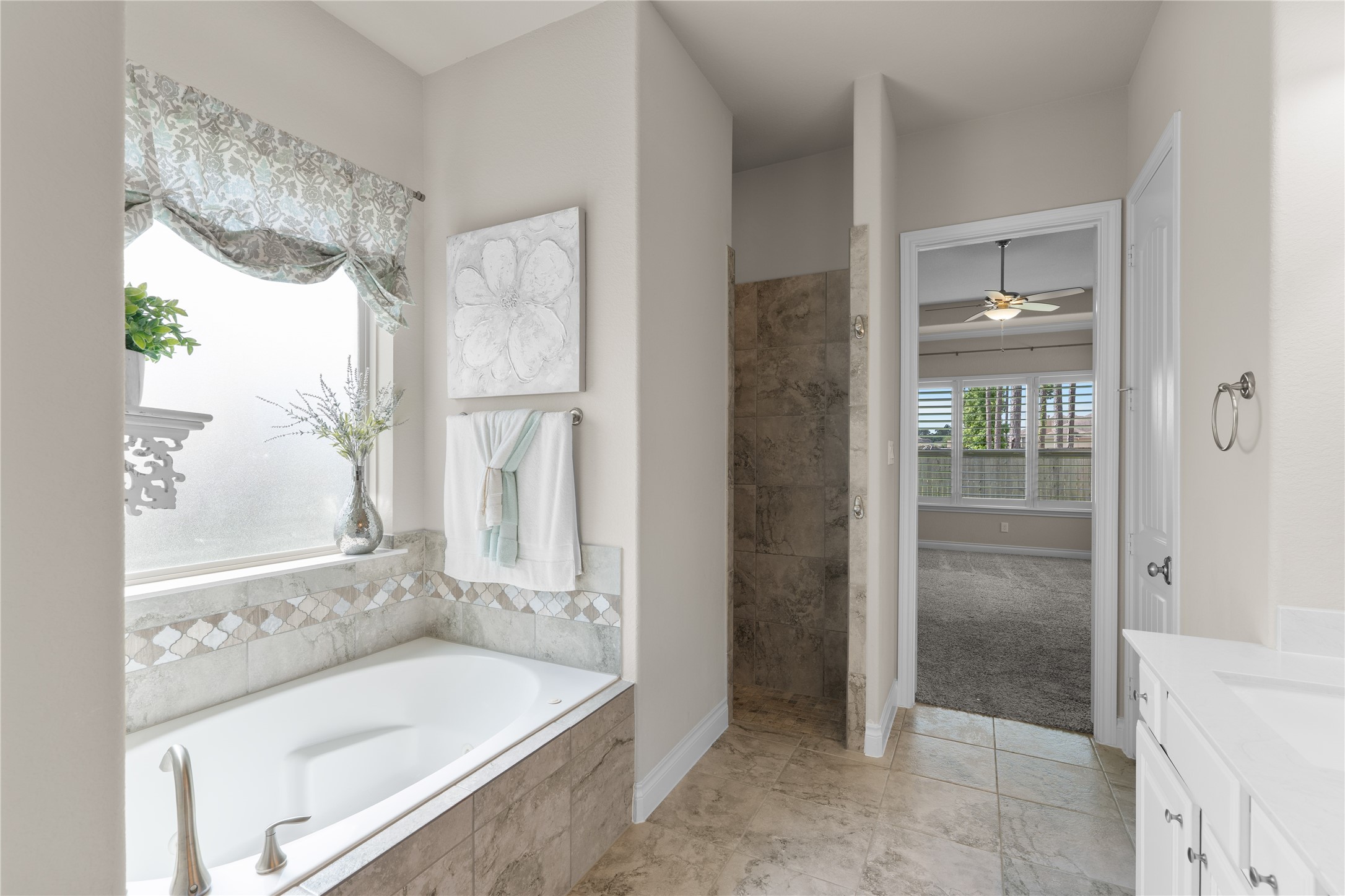Primary bath featuring a soaking tub and large walk-in shower.