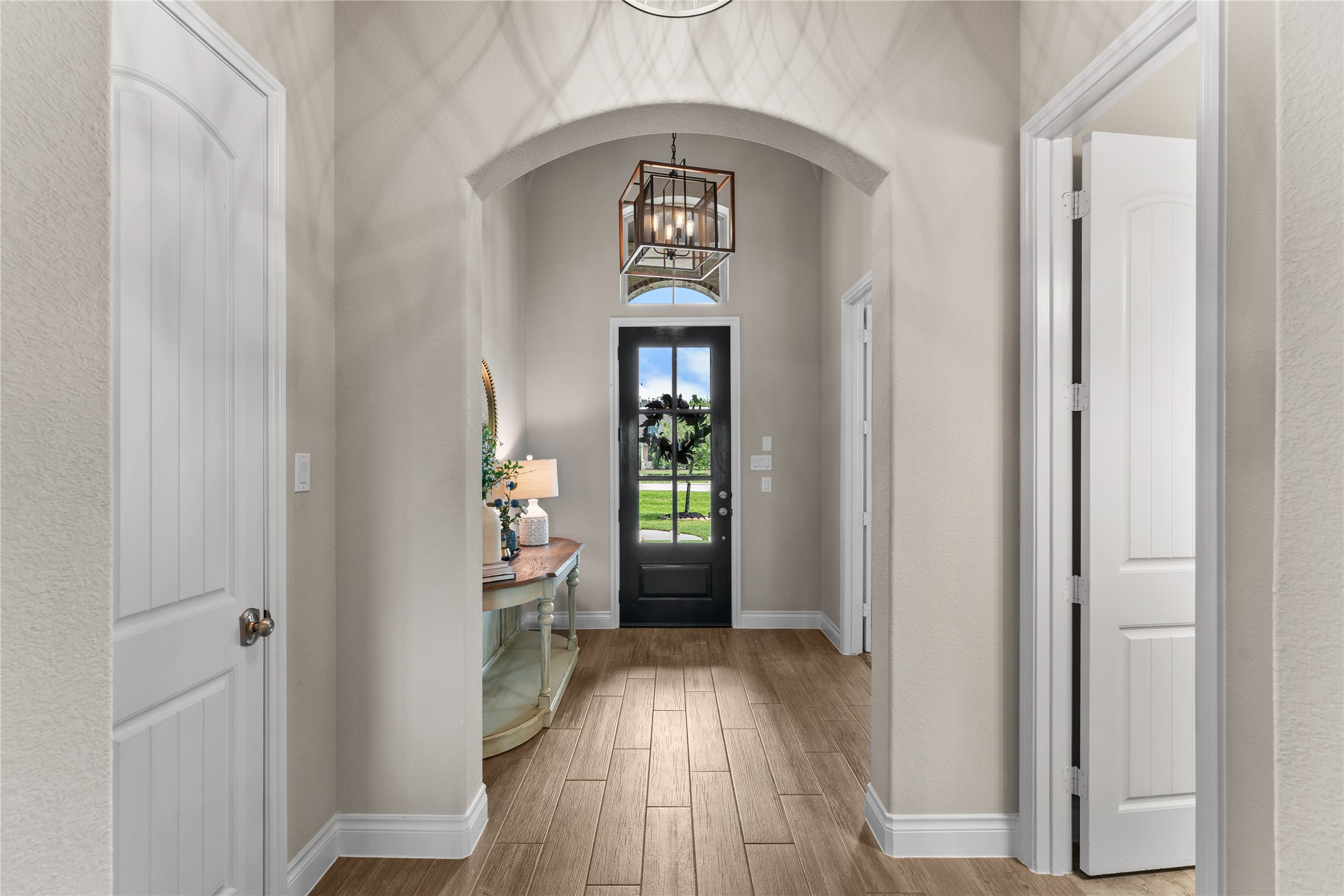 Inviting entry with architectural details and warm natural light throughout