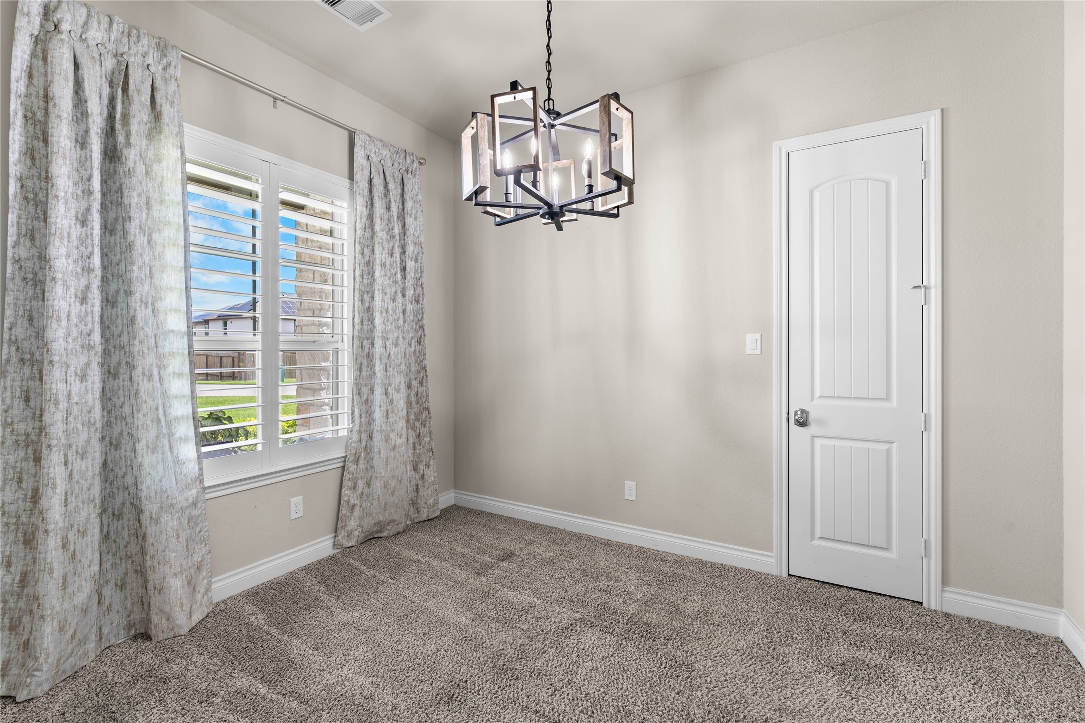 Secondary bedroom with soft natural light and generous proportions.