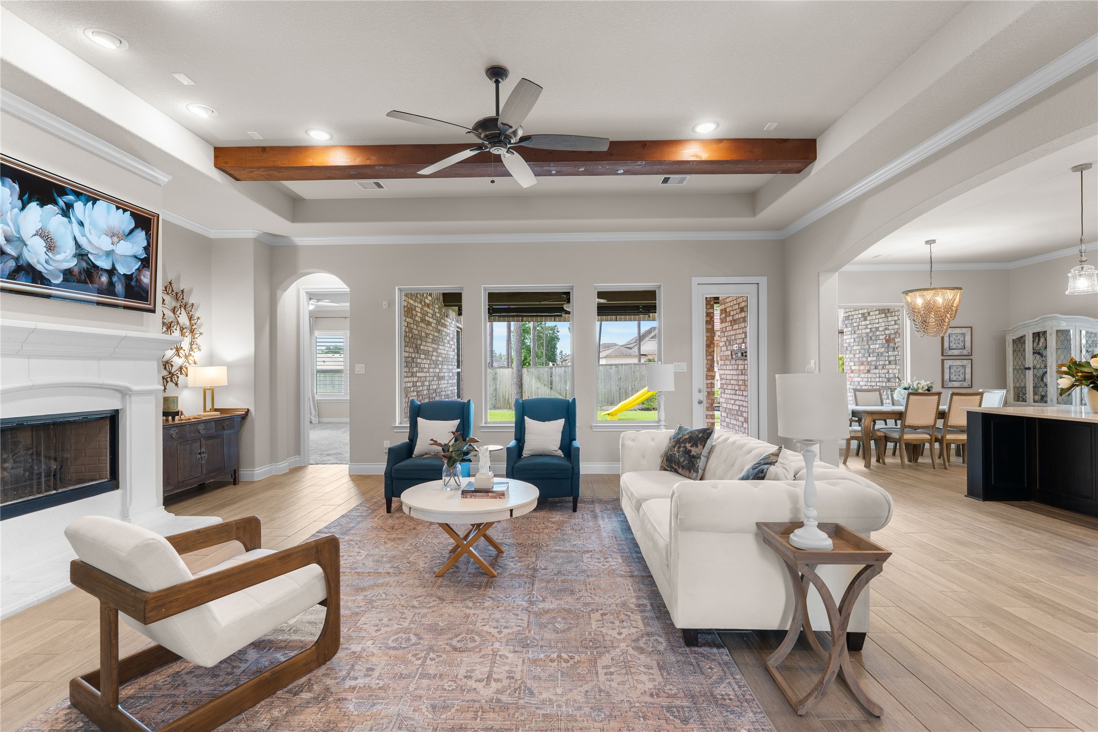 Spacious family room centered around custom ceiling details and a cozy fireplace