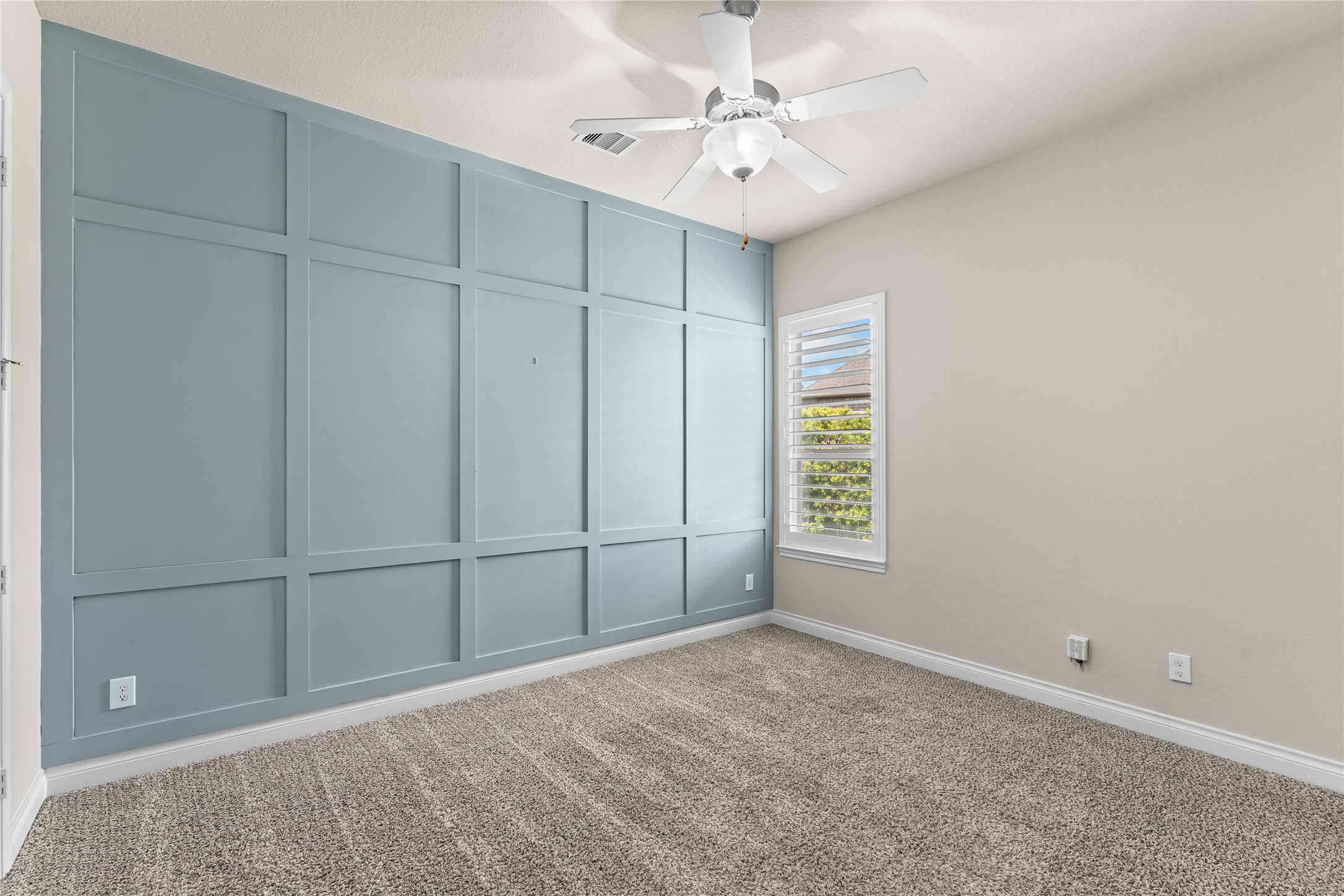 Secondary bedroom with accent wall