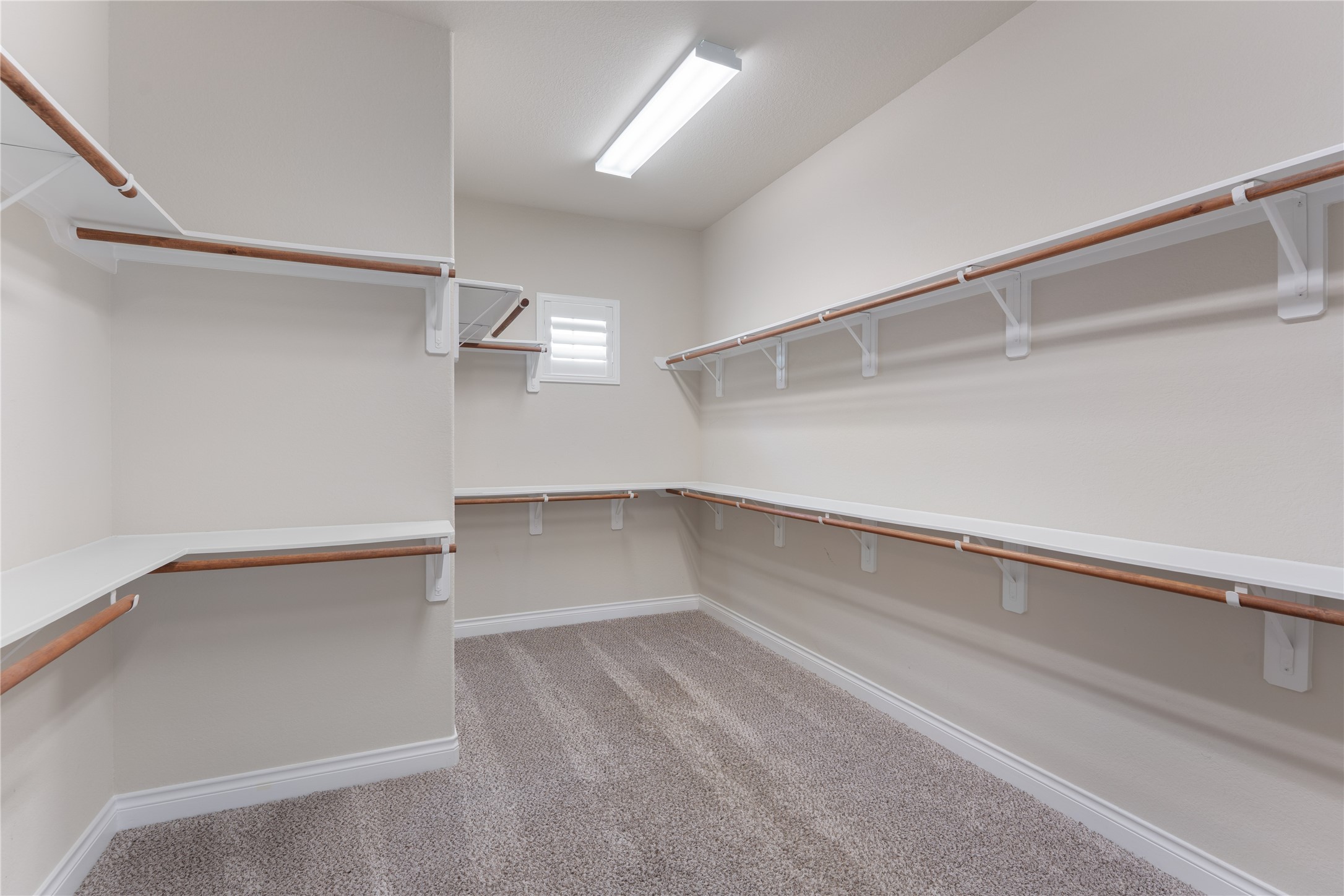 Expansive walk-in closet with custom built-ins and exceptional storage.