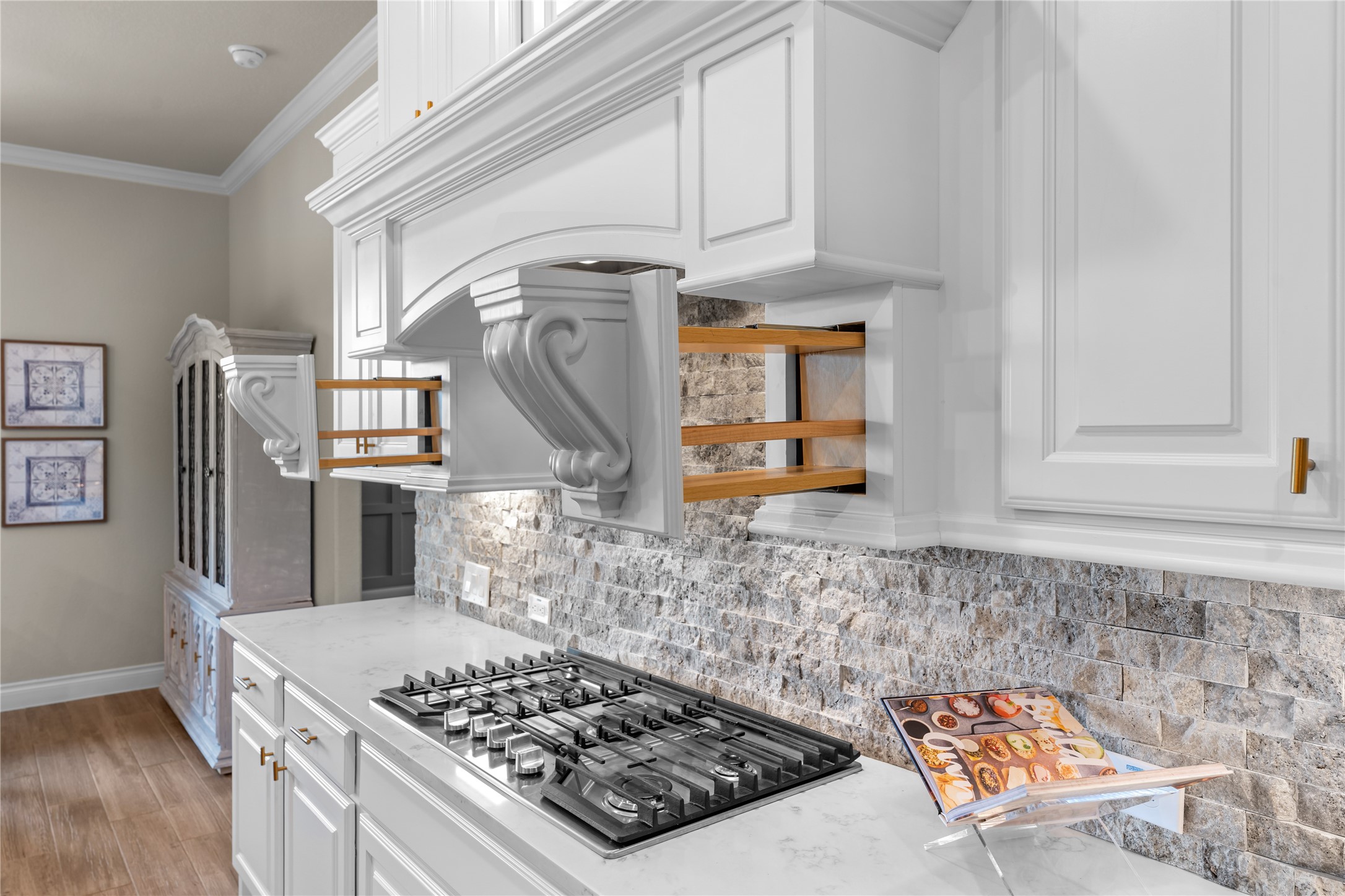 Designer finishes with custom cabinets and gas cooktop create a polished culinary space