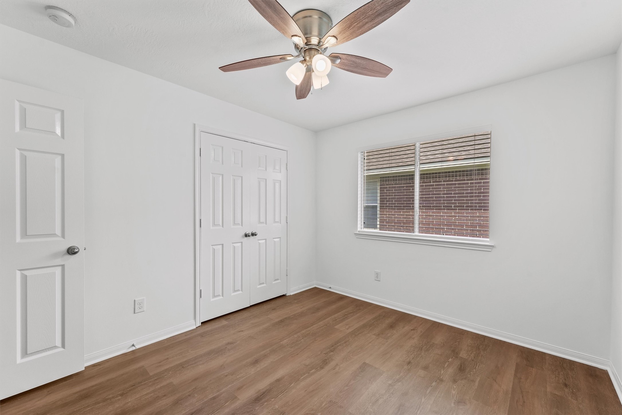 Secondary bedrooms both have ceiling fans and new flooring.