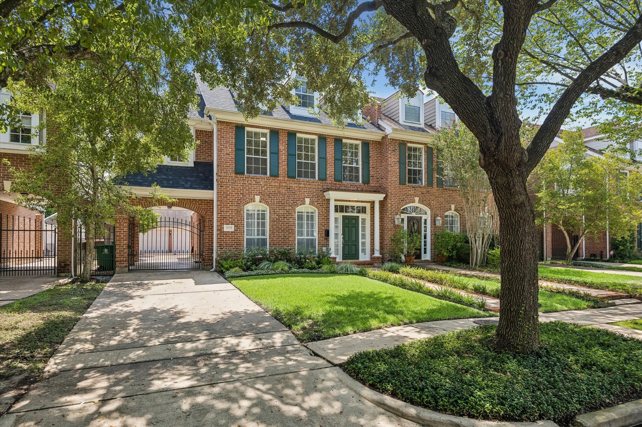 Driveway with gate, porte-cochre, and detached 2 car agarage.
