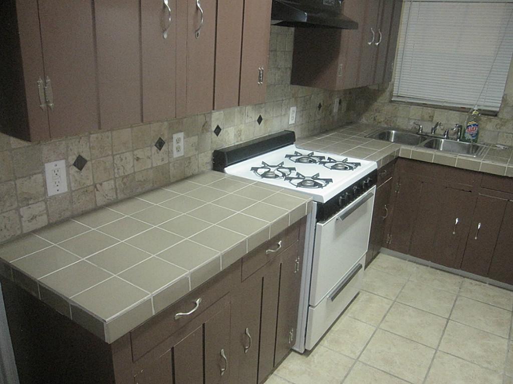 Tiled countertops and flooring throughout kitchen