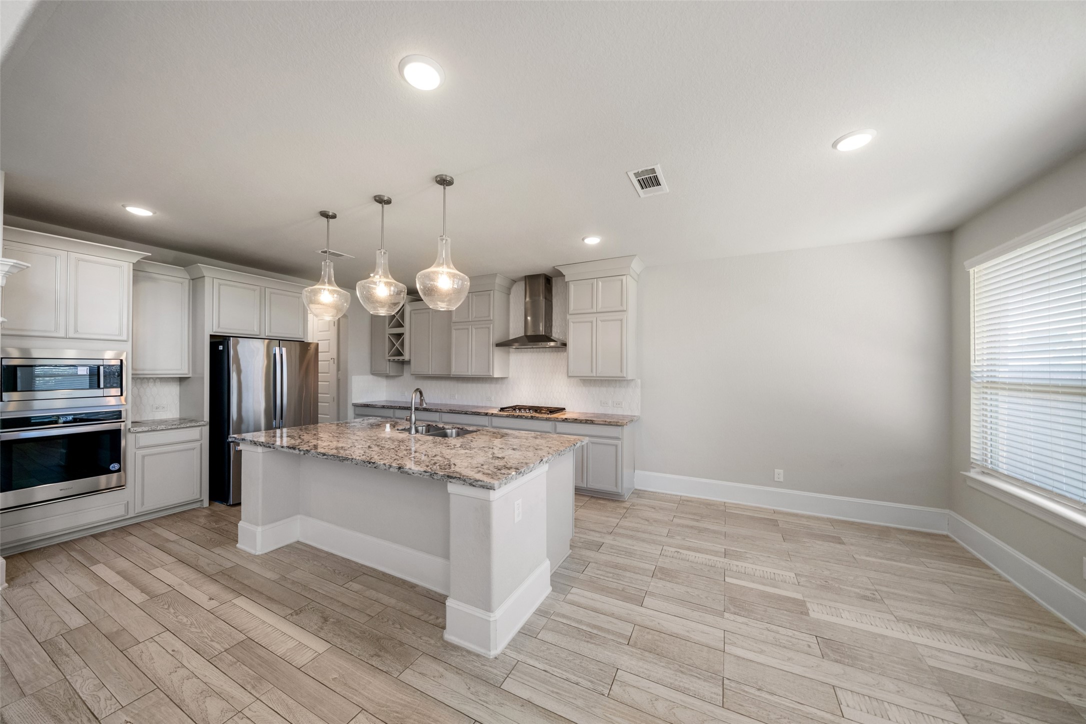 This kitchen is open to the living room and offers a breakfast bar and breakfast room.
