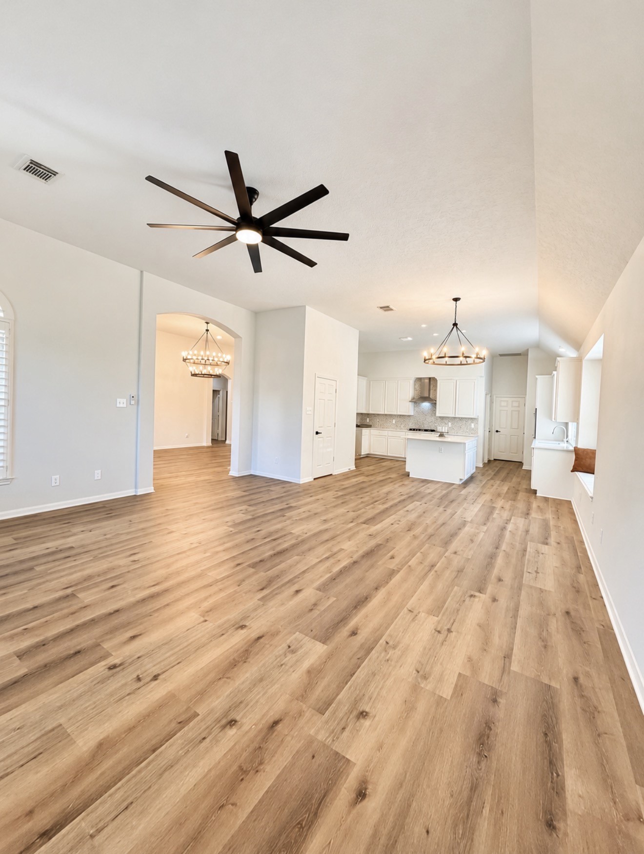 The large space w/ high ceilings includes the family area, breakfast area, and kitchen