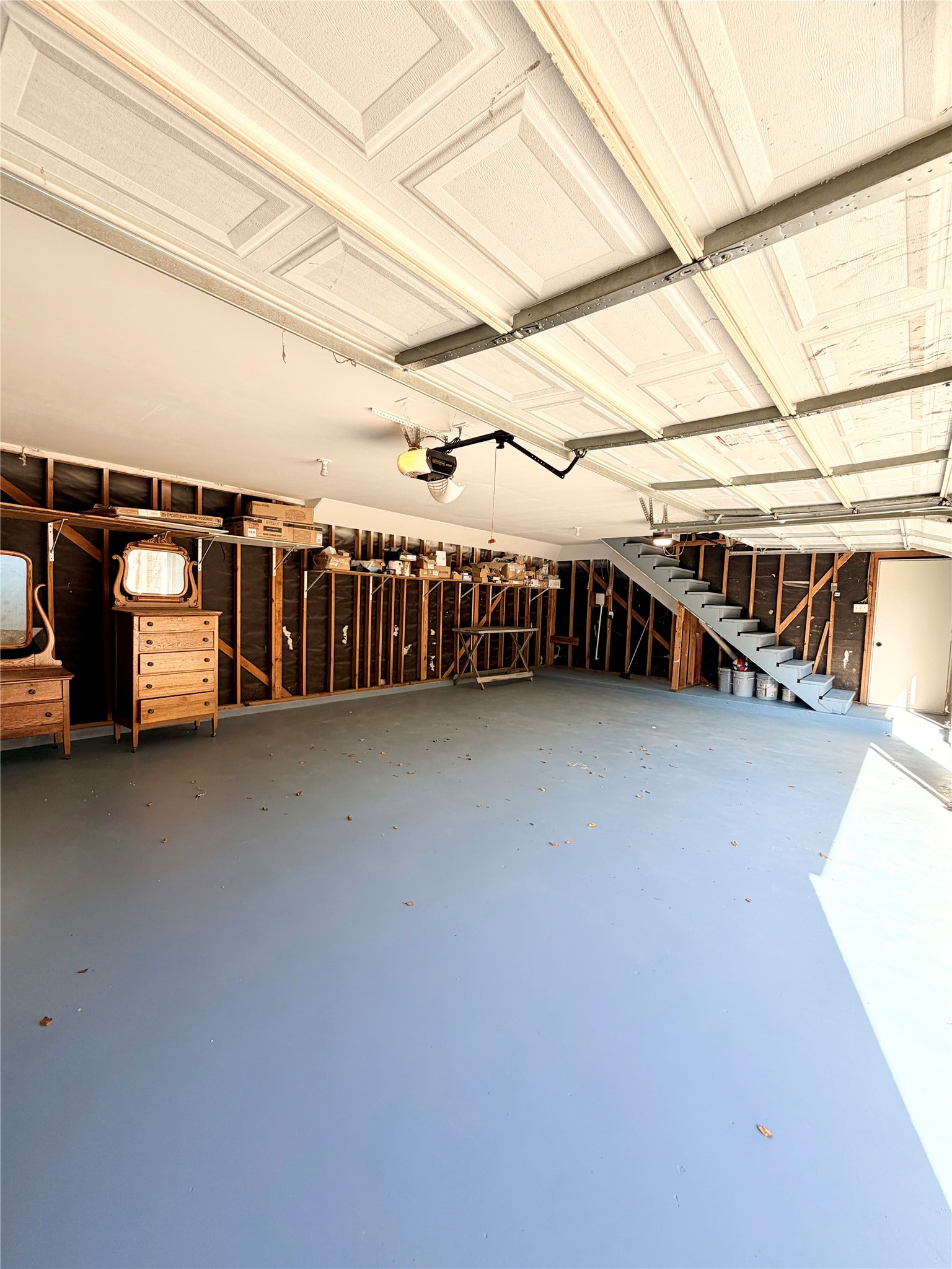 3 car garage w/ stairs leading to the ADU above (bedroom & ensuite bathroom)