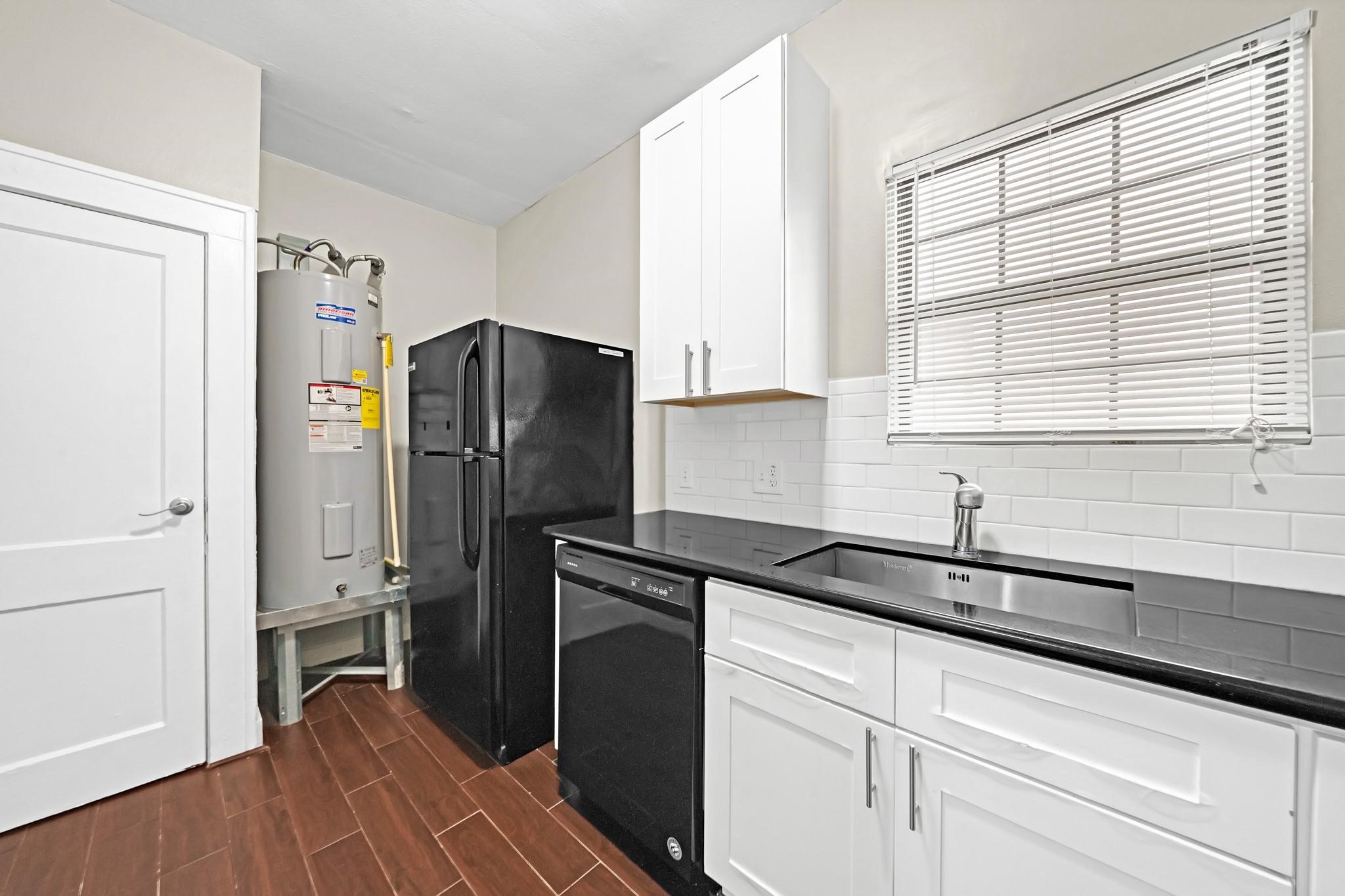 Refreshed kitchen featuring granite countertops and plenty of cabinet space. Refrigerator included. Refreshed kitchen featuring granite countertops and plenty of cabinet space. Refrigerator included.
