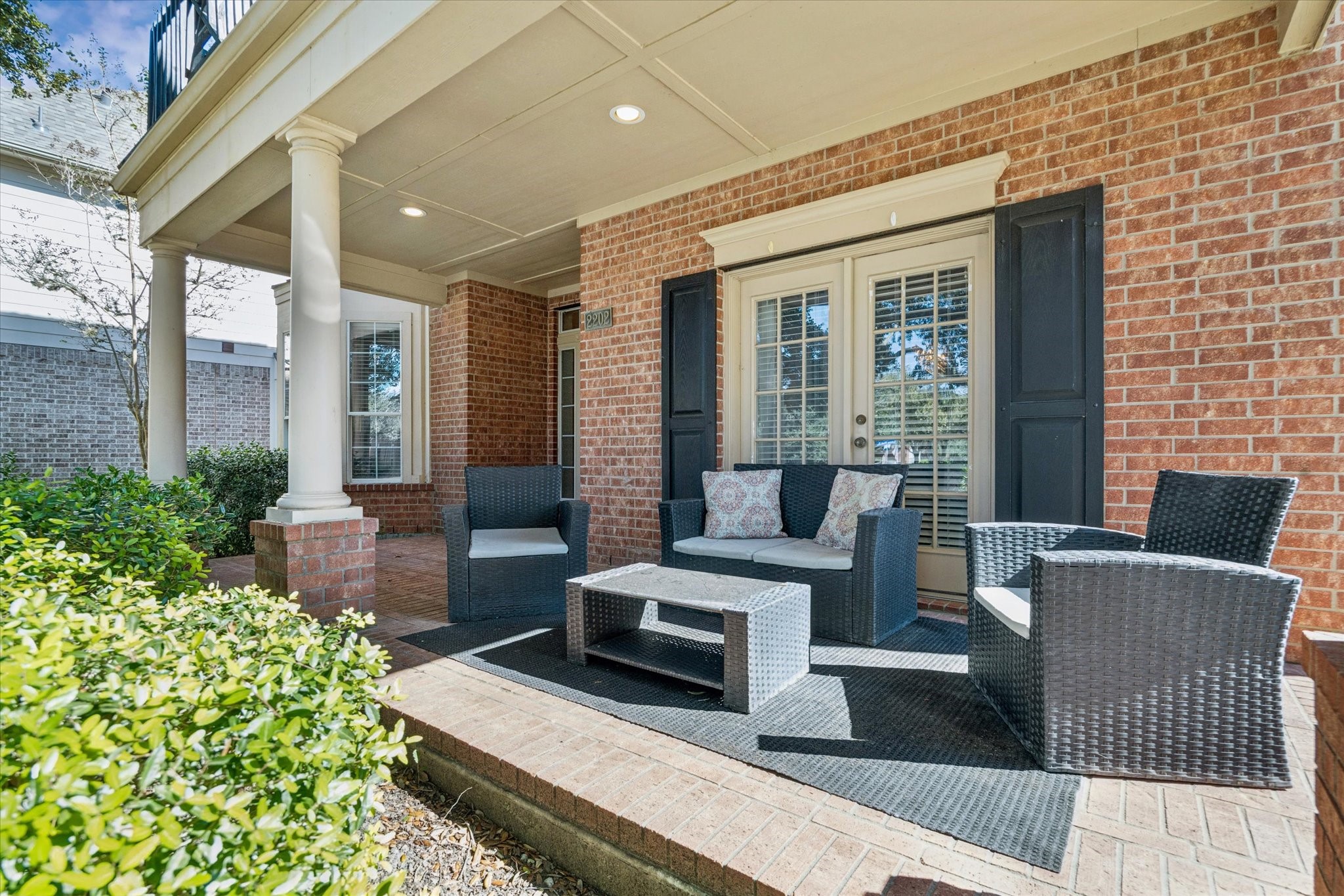 INVITING COVERED FRONT PORCH WITH BRICK DETAILING AND PLENTY OF SPACE TO RELAX OR GREET GUESTS YEAR-ROUND. INVITING COVERED FRONT PORCH WITH BRICK DETAILING AND PLENTY OF SPACE TO RELAX OR GREET GUESTS YEAR-ROUND.
