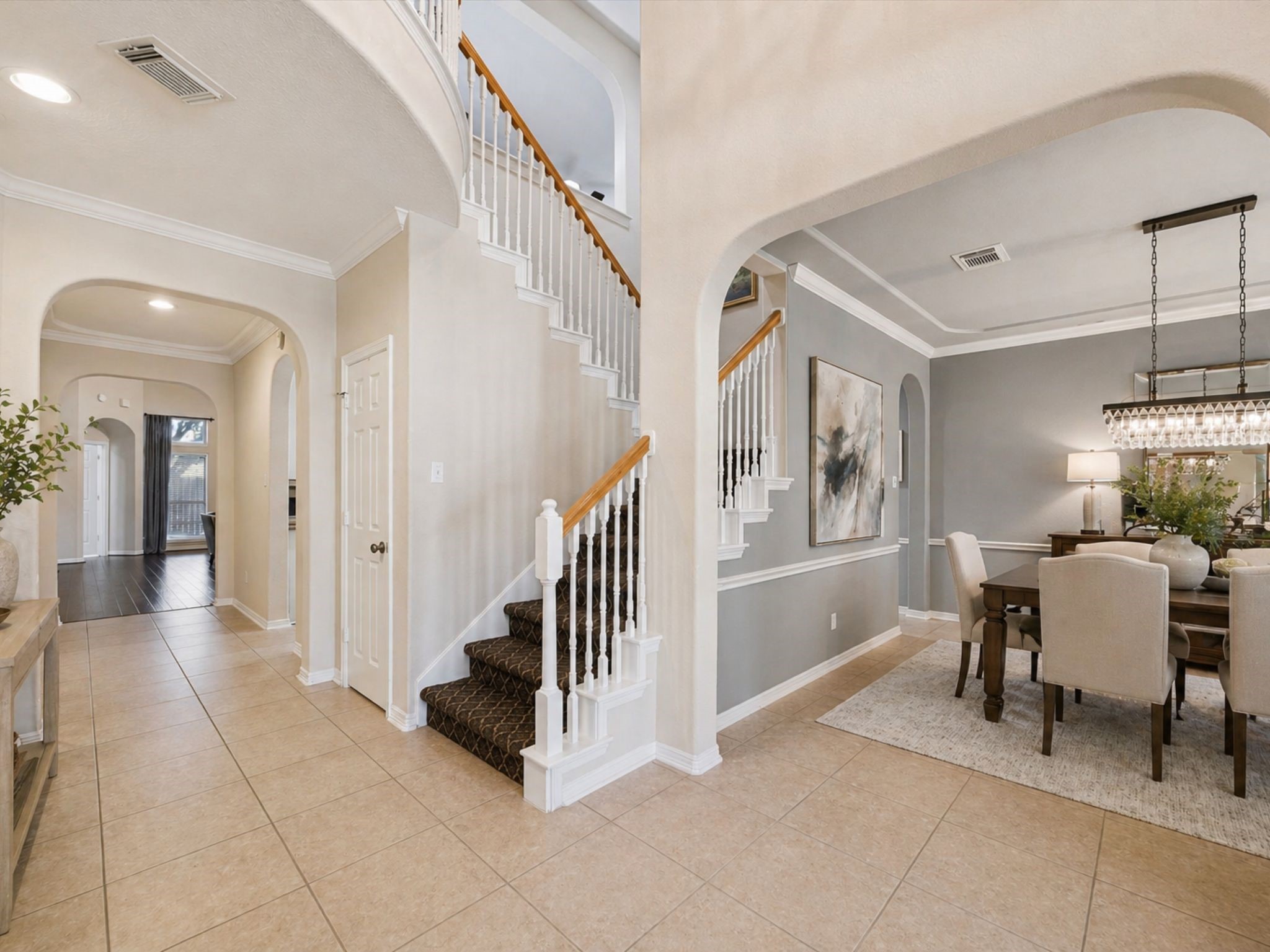 GRAND ENTRY WITH HIGH CEILINGS, CURVED STAIRCASE, AND ARCHITECTURAL DETAILS THROUGHOUT. GRAND ENTRY WITH HIGH CEILINGS, CURVED STAIRCASE, AND ARCHITECTURAL DETAILS THROUGHOUT.