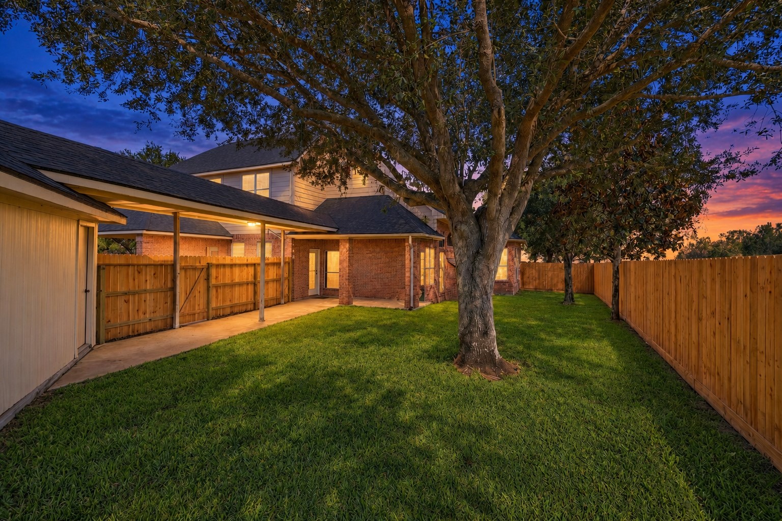 SPACIOUS BACKYARD WITH MATURE SHADE TREE AND LARGE GRASS AREA, PERFECT FOR OUTDOOR ENJOYMENT.