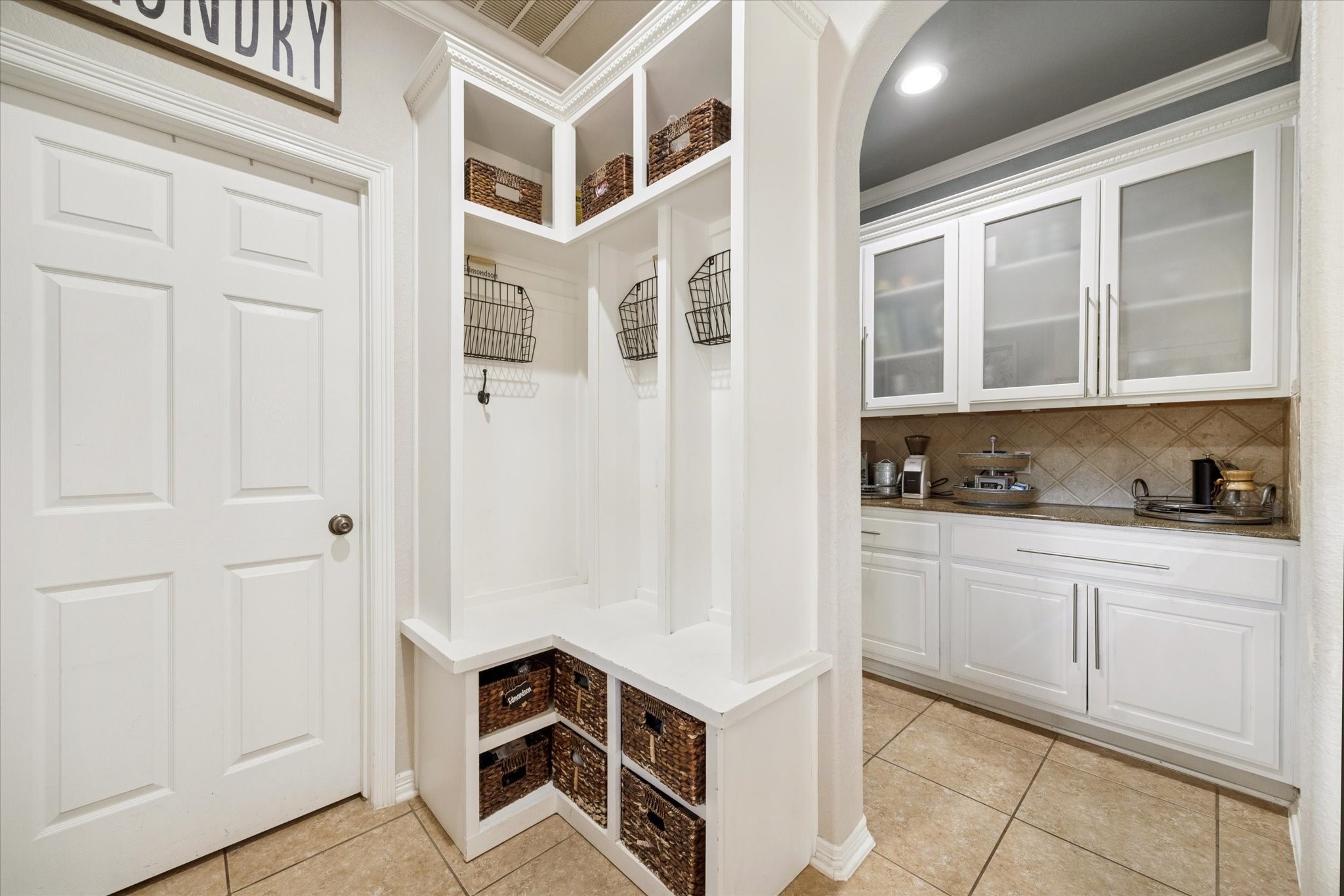 CUSTOM BUILT-IN MUD AREA WITH STORAGE, HOOKS, AND ORGANIZATION FEATURES PERFECT FOR EVERYDAY FUNCTIONALITY.
