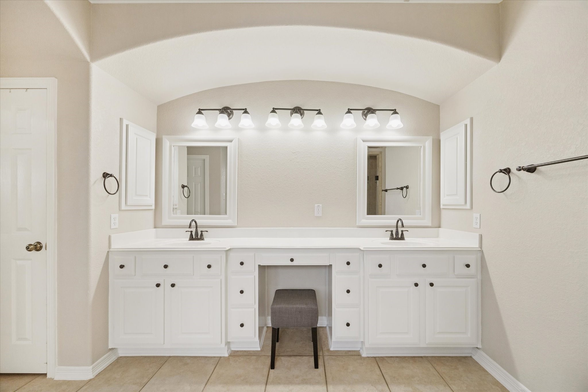 DOUBLE VANITY SETUP WITH AMPLE STORAGE AND COUNTER SPACE, IDEAL FOR A BUSY HOUSEHOLD.