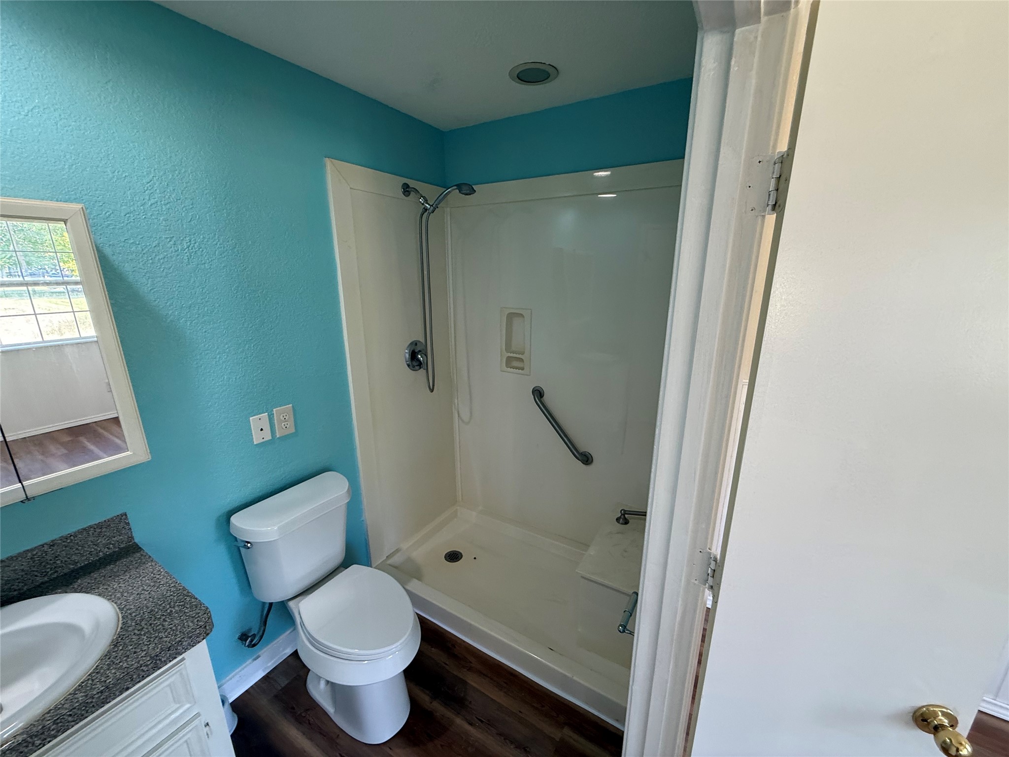 Alternate bathroom view showing the tub/shower combination and vanity.