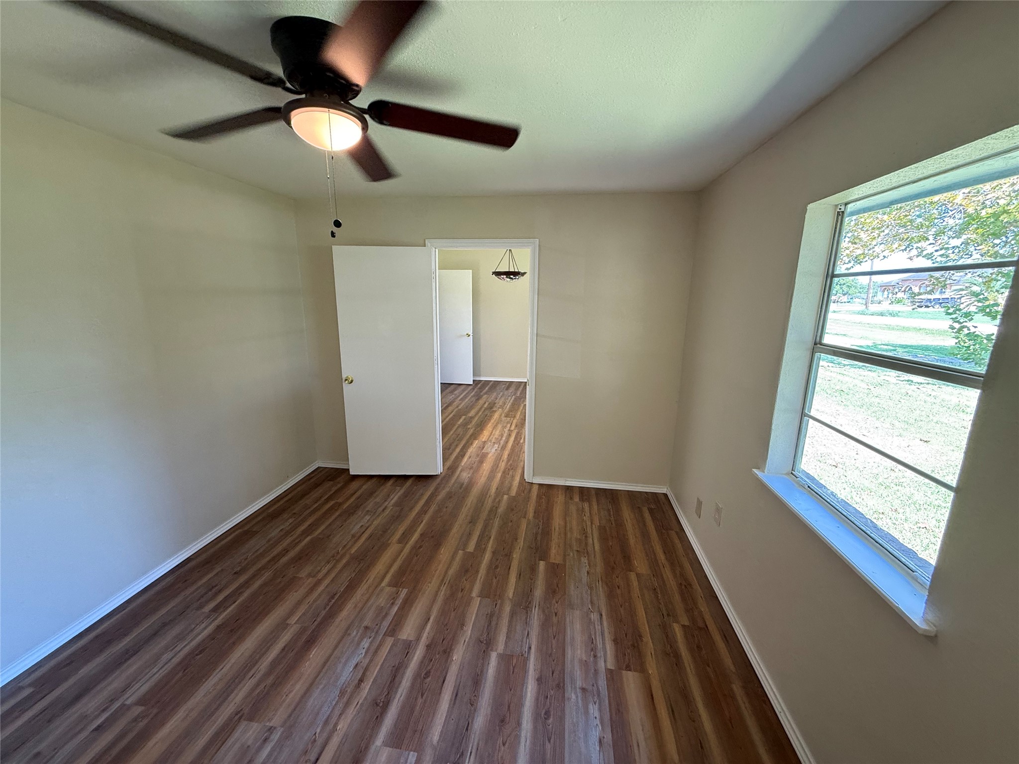 Alternate view of the room showing natural light and access to the adjoining interior.