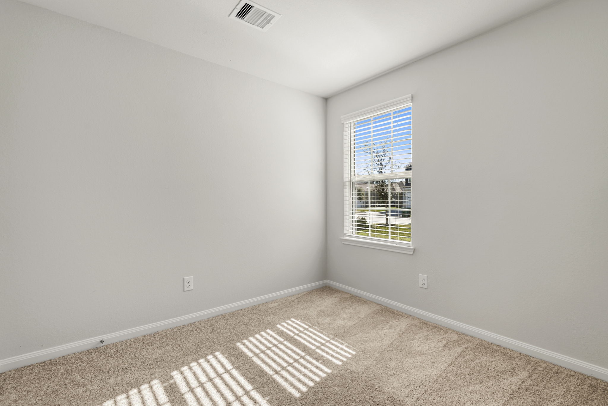 One of the two additional bedrooms in the home.