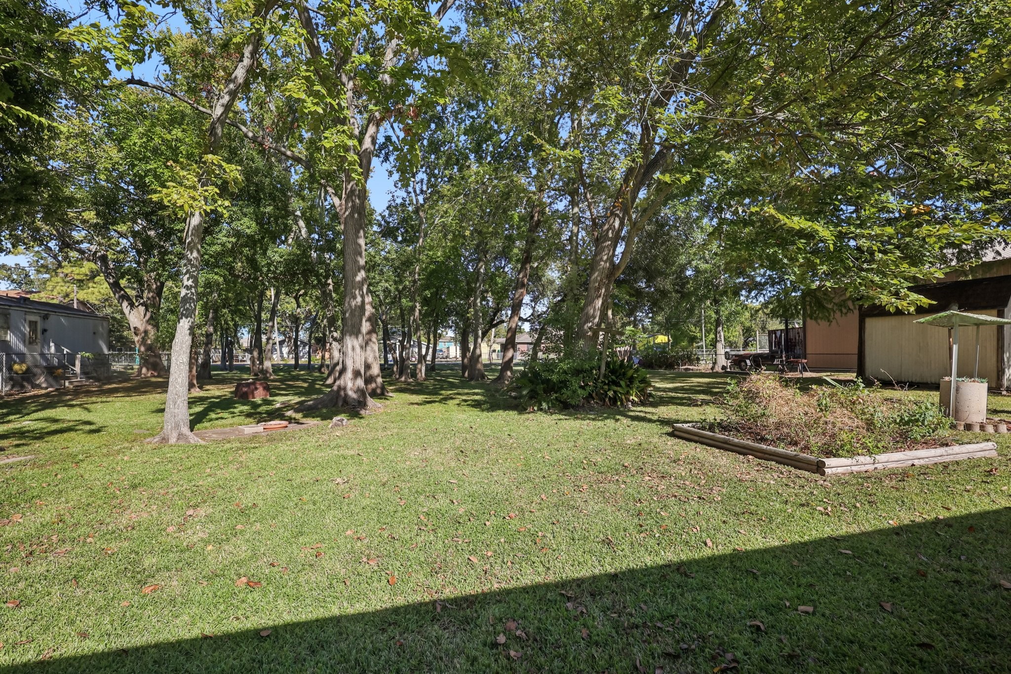 The back yard is massive and extends to the street behind the home. Dozens of mature trees provide ample shade year round.