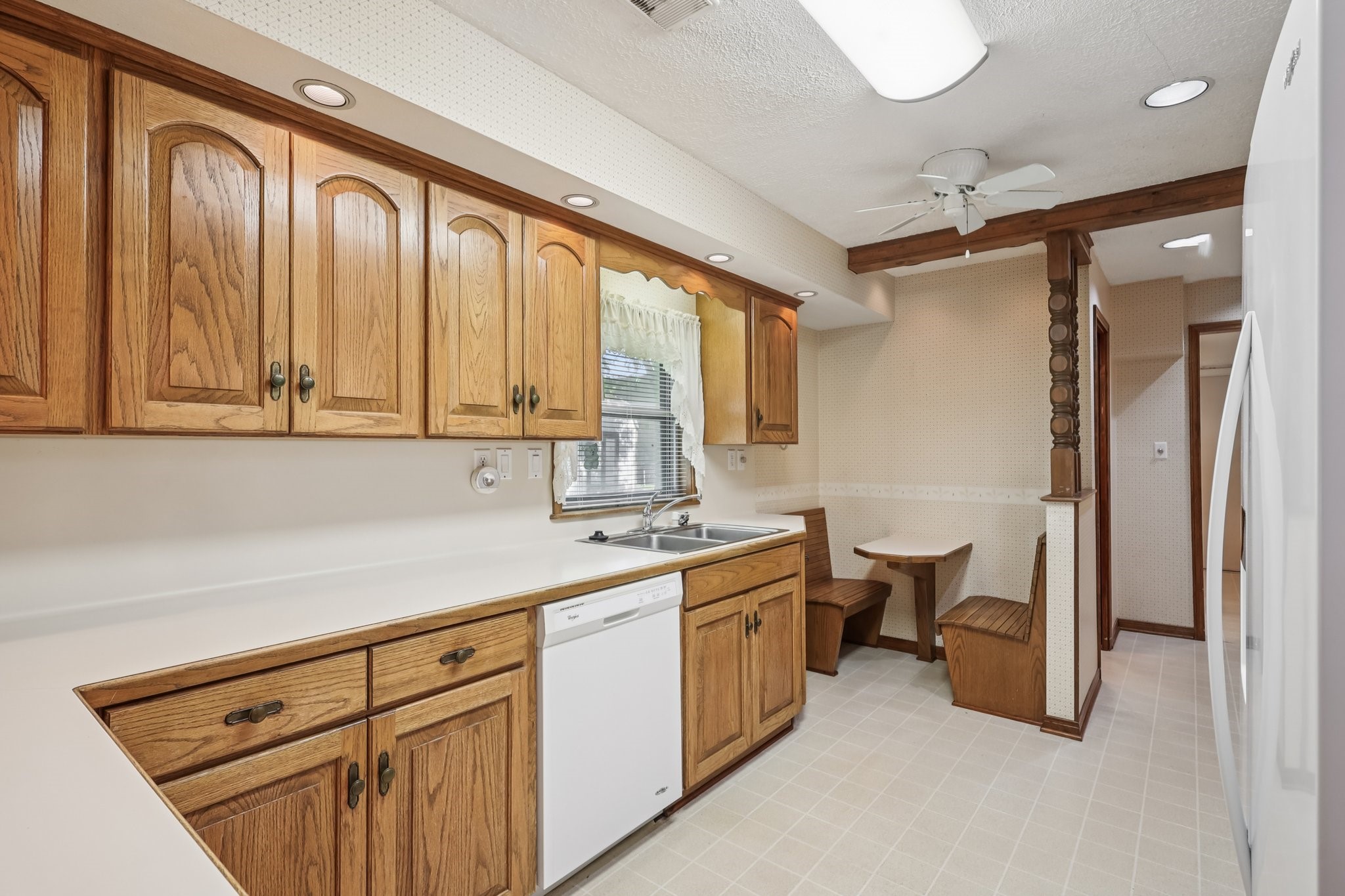 The kitchen features solid wood cabinets and a great built in seating area for two...