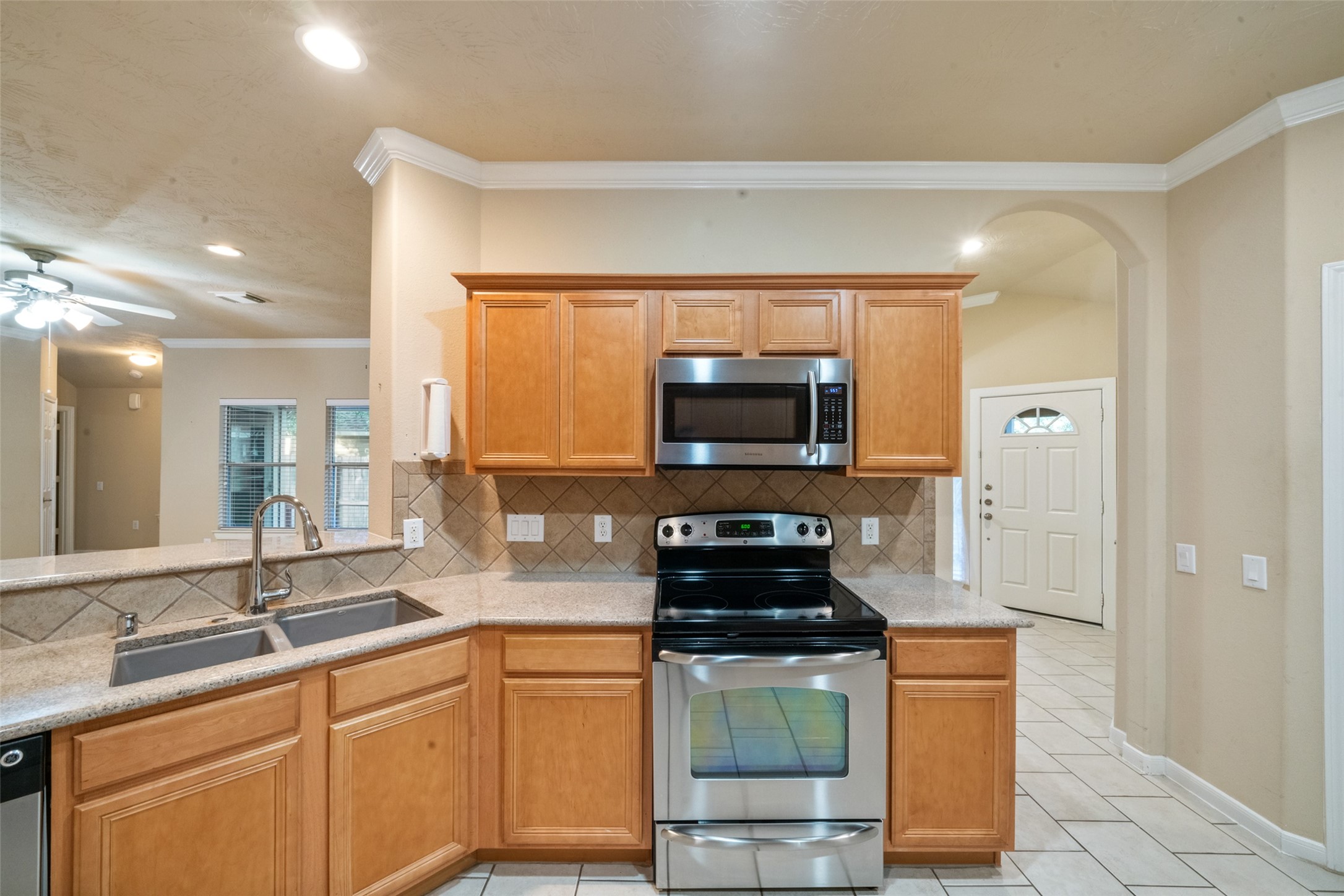 Stainless appliances, granite countertops and a sit at bar.
