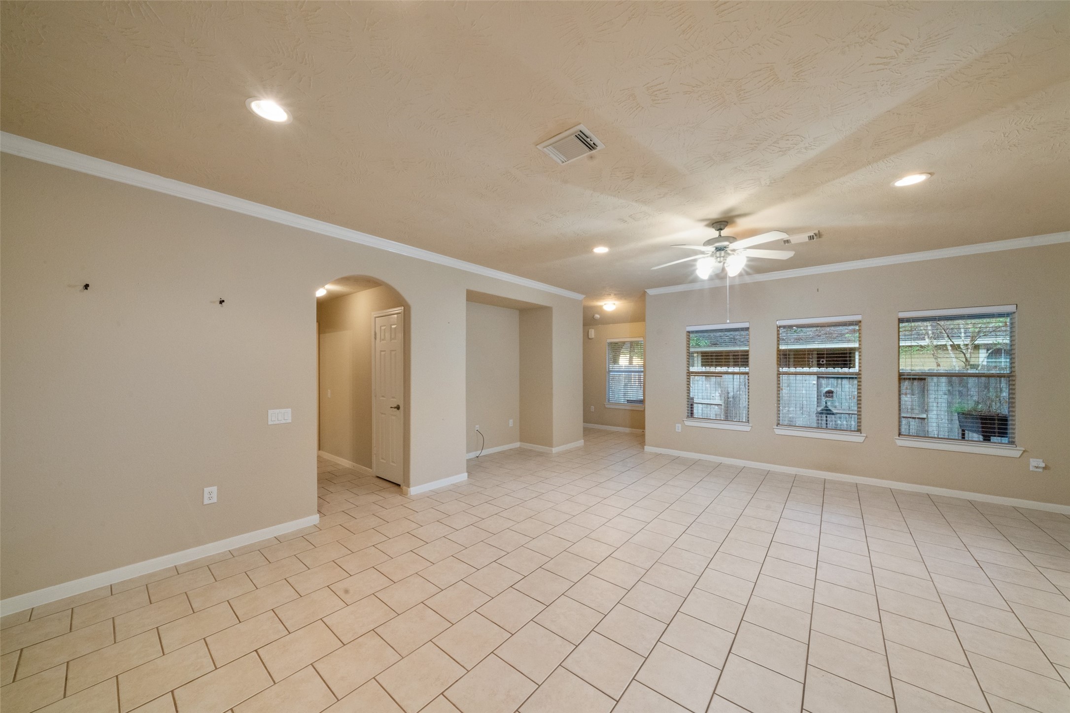 Secondary bed and bath through the arched doorway. Hall has additional storage closet.