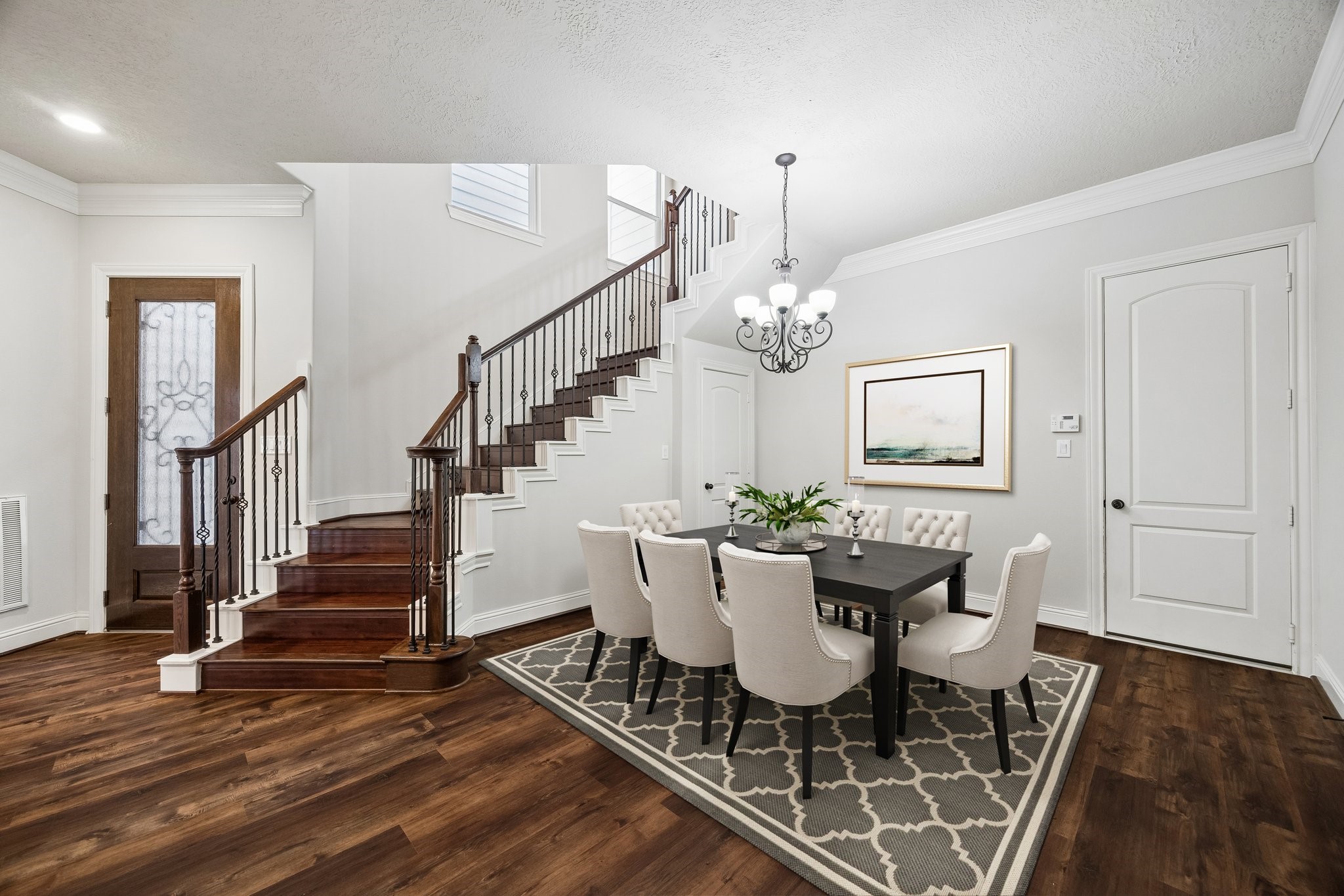 Spacious dining area with stylish staircase and functional layout.