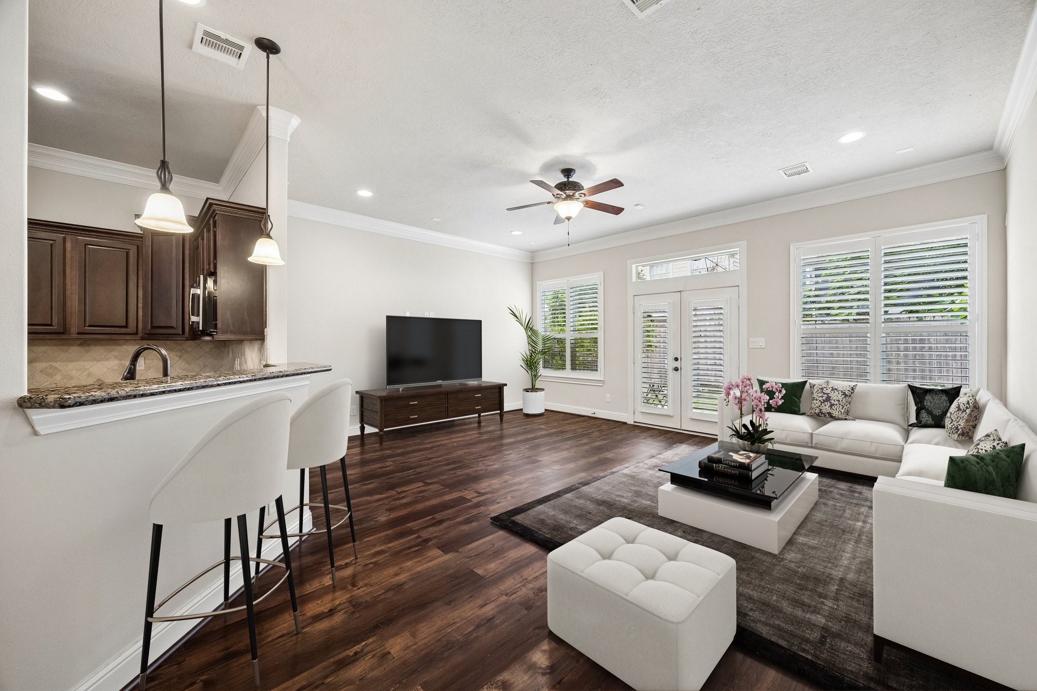 Open living and dining area with natural light and backyard views.