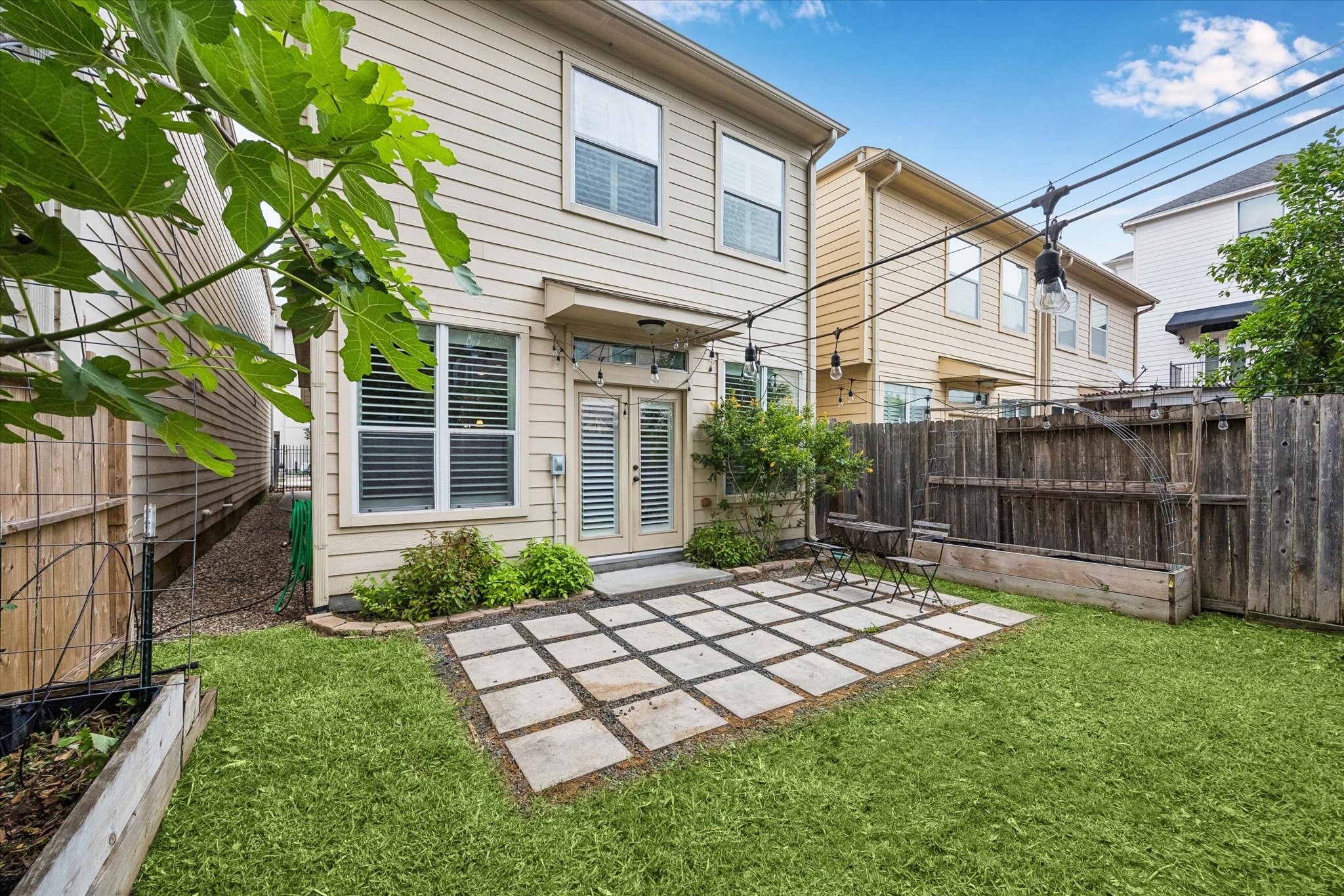Private backyard with patio grid design and low-maintenance green space.