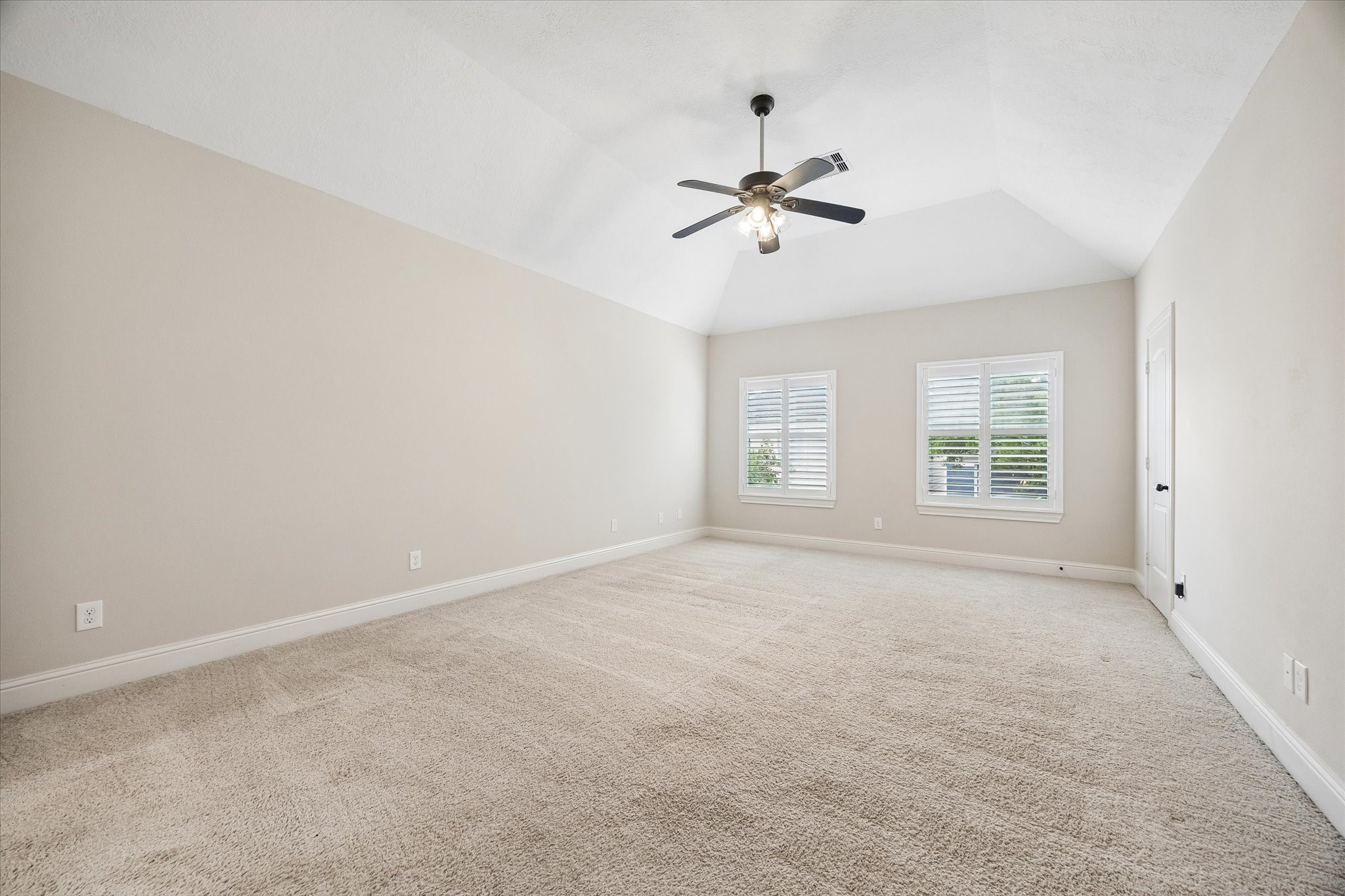 Large upstairs room with vaulted ceiling and versatile use options.